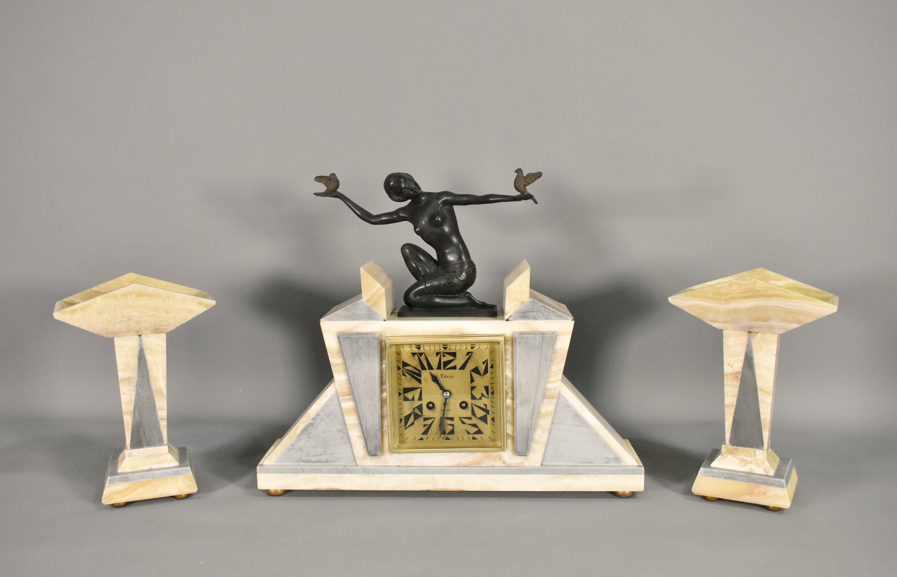 French Art Deco Clock 
Garniture by H Molins-Balleste 
Tahou, Lourdes
 
This clock set is a beautiful example of high Art Deco styling, featuring a spelter figurine of a young woman kneeling with outstretched arms holding two birds.
 
The