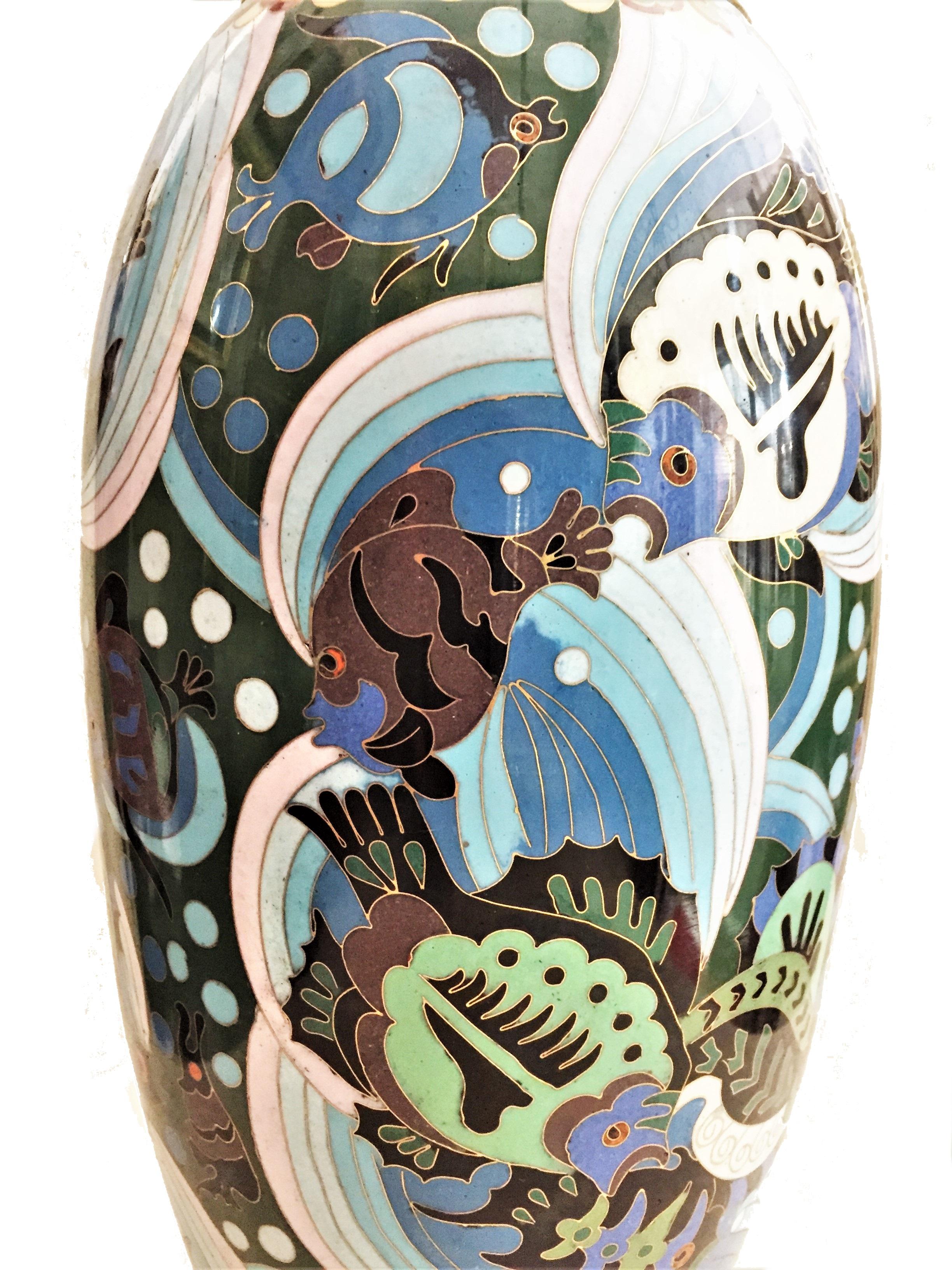 Dimensions:
Height: 15-1/4 inches 
Diameter: 7 inches

Probably, by Maison Paul Lauchet Paris, this elegant French Art Deco flower vase combines the simplicity and brevity of lines of the stylized fish and sea horses on the foreground of sea