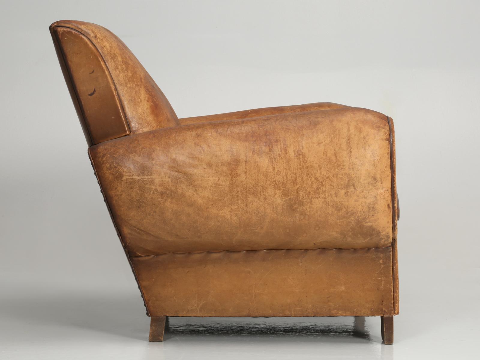 French Art Deco leather club chair, that our in house upholstery department has carefully disassembled and rebuilt as necessary from the bottom up and made it look as though we never touched it. This is a single French leather club chair that was
