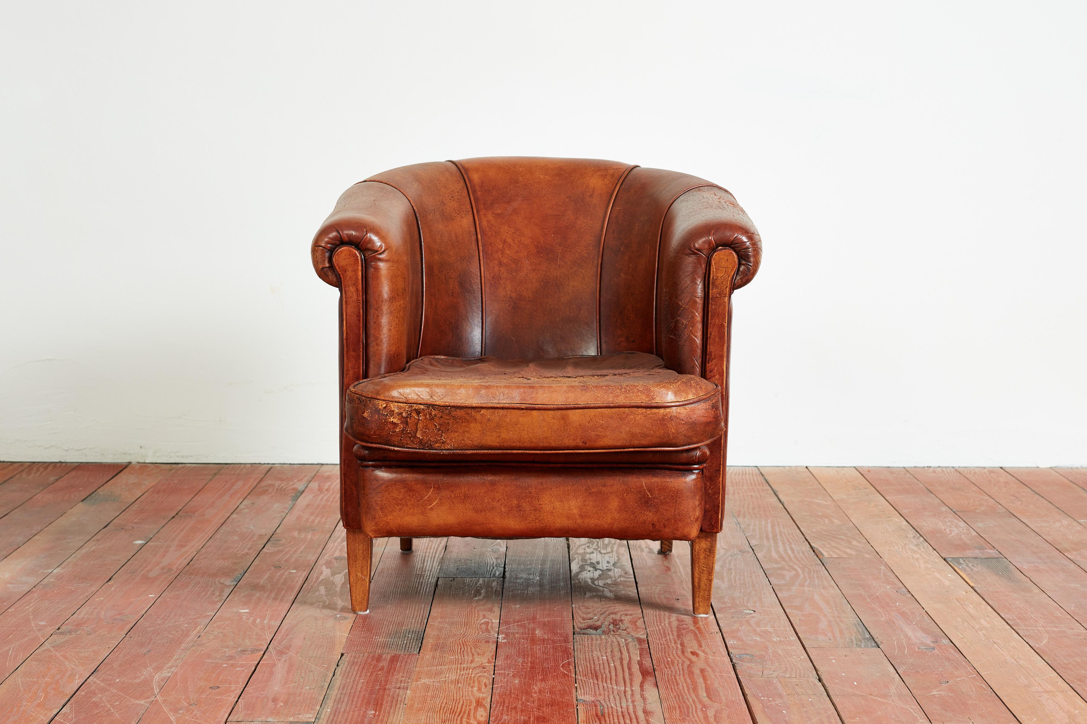 Wonderful French barrel back club chair in rich leather with great patina and wear. Petite in scale but large in style! 
 