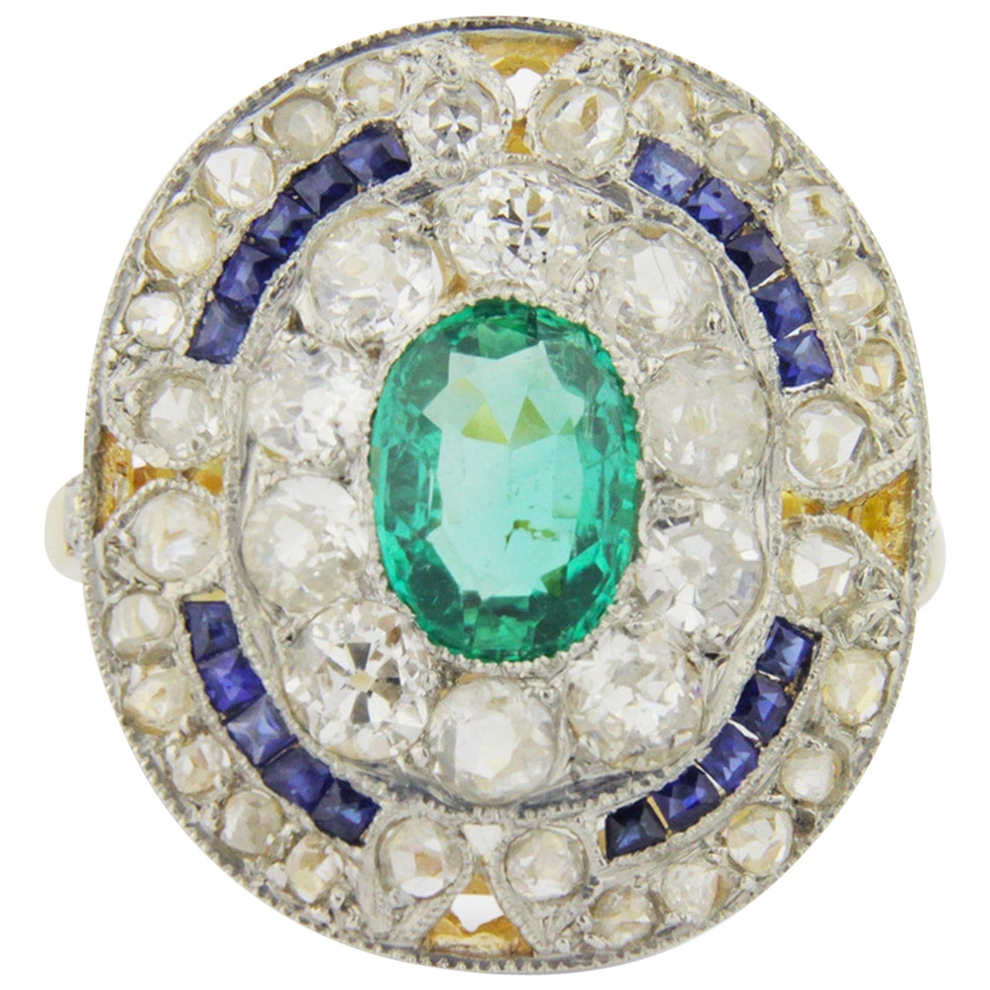French Art Deco Cocktail Ring with an Emerald, Diamonds and Sapphires