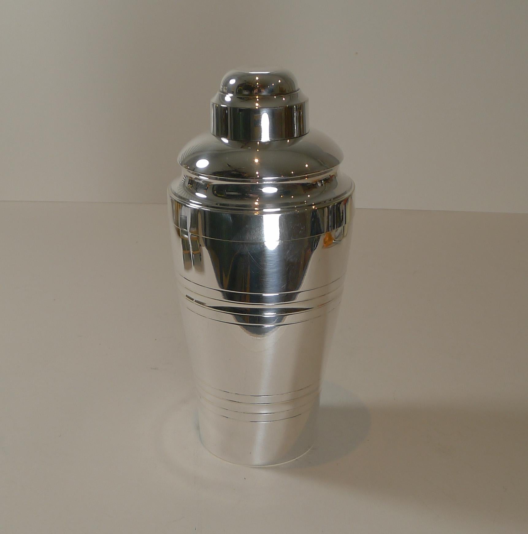 A fabulous vintage French cocktail shaker made from silver plate and just back from our silversmith's workshop where it has been professionally cleaned and polished to gleam.

What makes this particularly sought after is the integral lemon