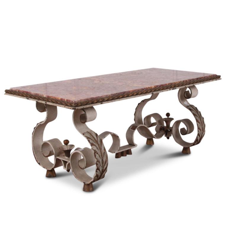 A French Art Deco coffee table with a boldly-formed wrought-iron painted-and-gilt base beneath a marble top with a spiral-twisted wrought iron border. Very unique and distinctive.





   