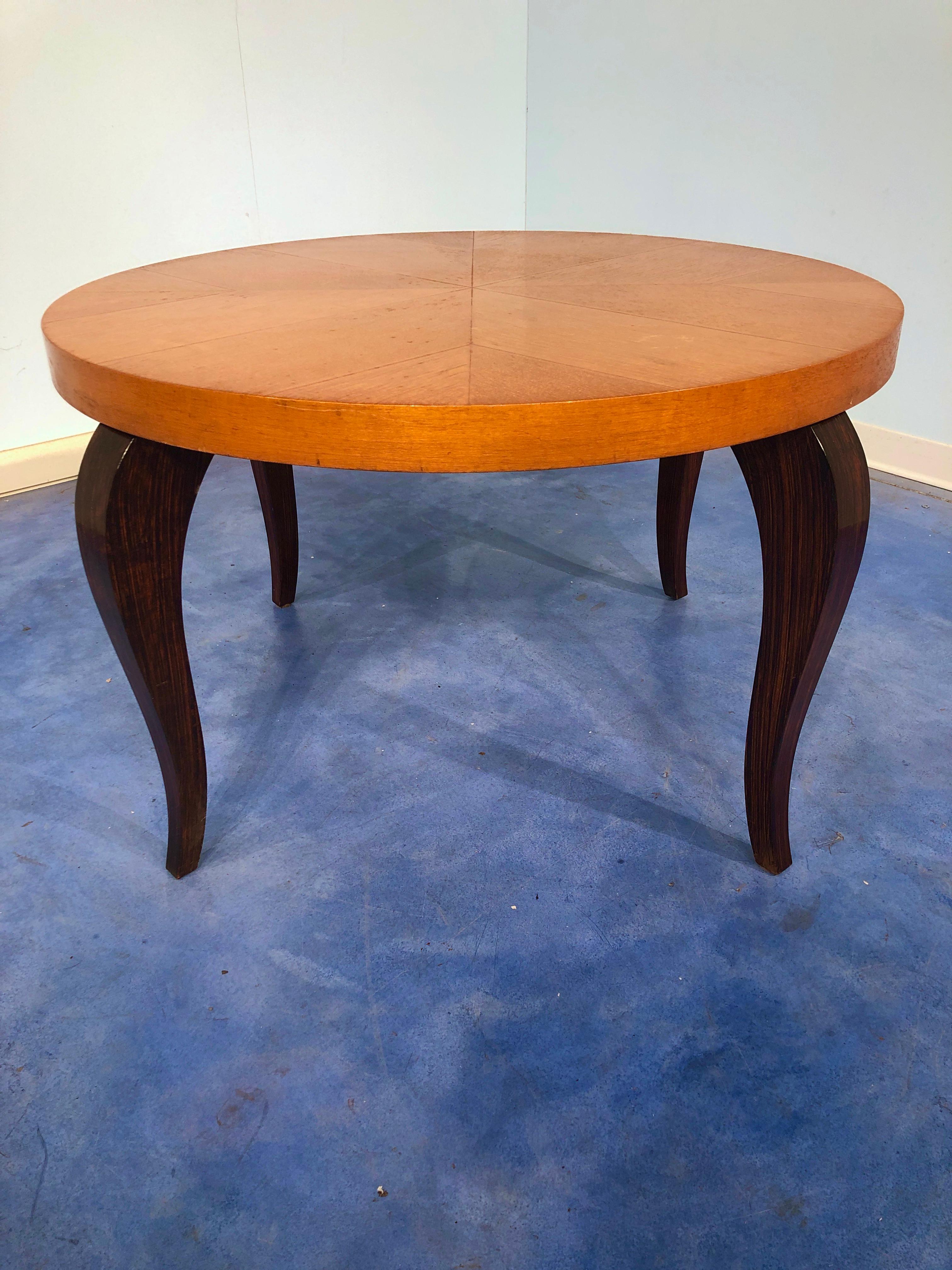 Simple but really beautiful French Art Deco coffee table, 1940.
It has a maple top and stylish legs that give a very elegant touch to the table.
You can see from the pictures the pattern on the top changes from different visual perspectives. 
 