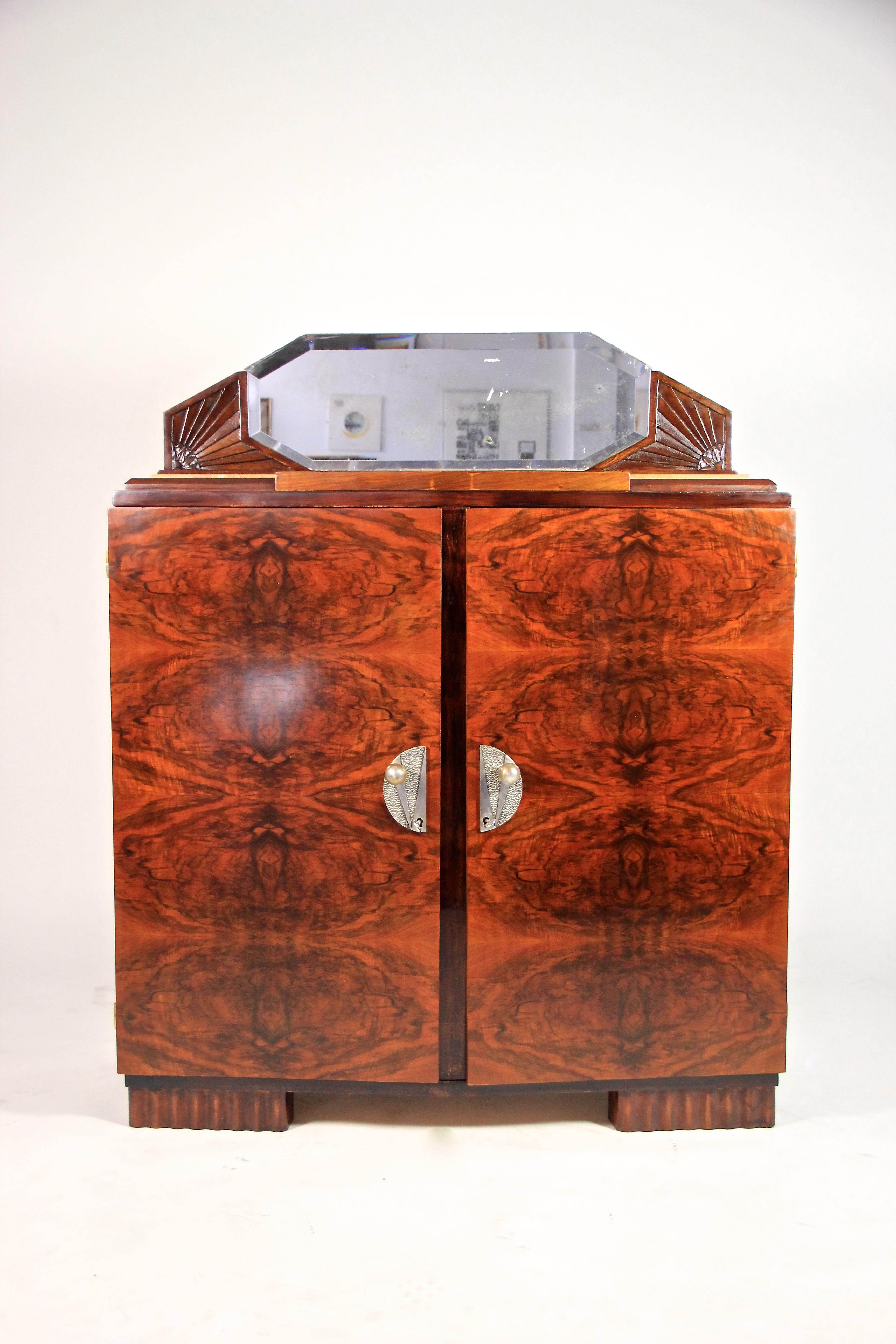 Phenomenal Art Deco commode or buffet from the period around 1925 in France. Amazing bookmatched burr walnut on the front was set in a very impressive manner and gives this fantastic designed Art Deco buffet an absolute great appearance. The divided