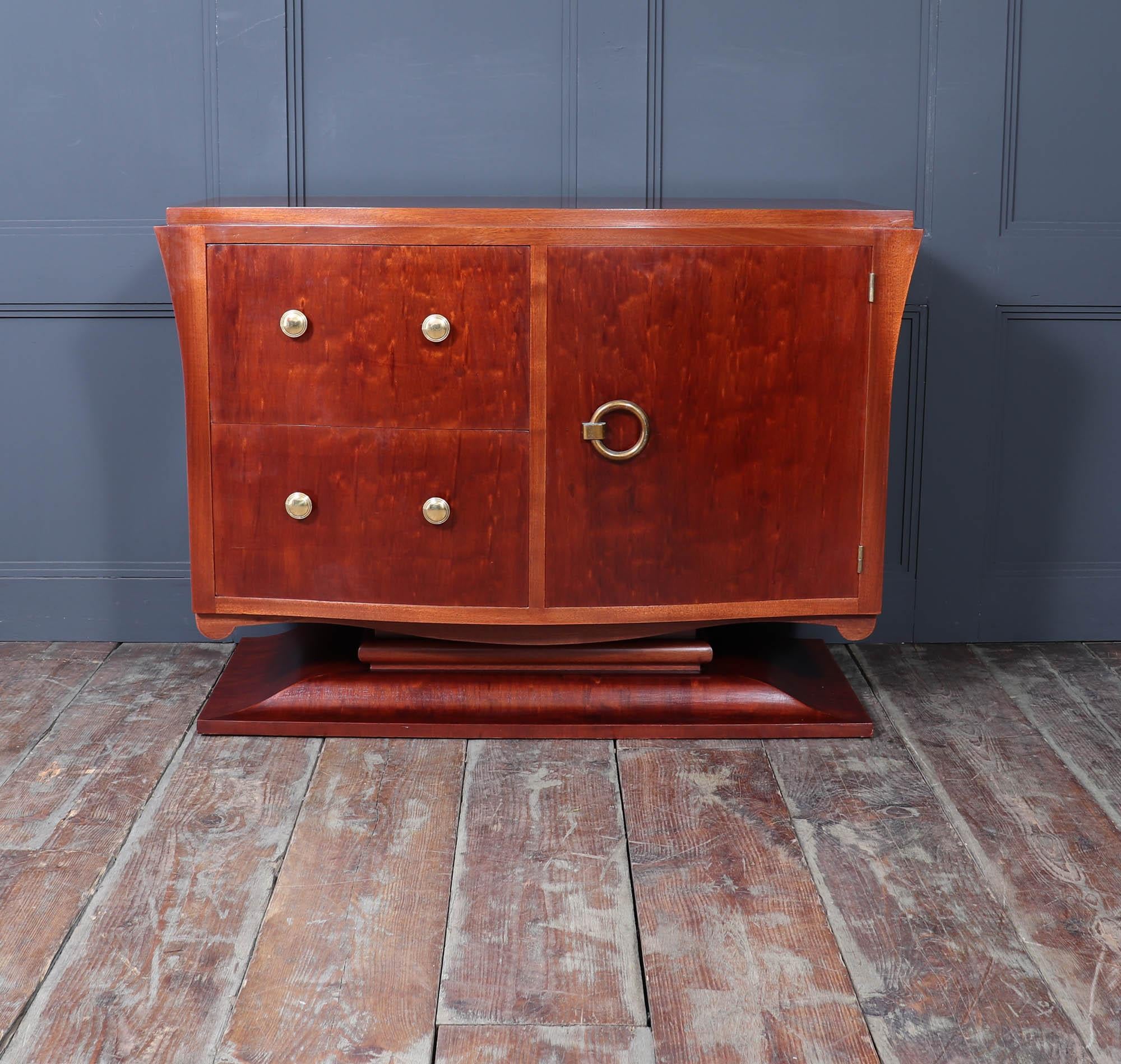 French Art Deco Commode
This stunning French Art Deco commode, a masterpiece from the 1930s that seamlessly blends functionality with timeless elegance. Crafted using exquisite Bubinga veneers, the chest features a captivating serpentine front and