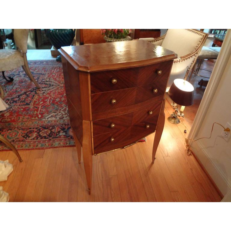 Handsome French Art Deco Jules Leleu style four-drawer commode, chest or table with geometrically inlaid design and bronze mounts and hardware, circa 1935. This chest can be used as a side table or nightstand. Great storage cabinet.