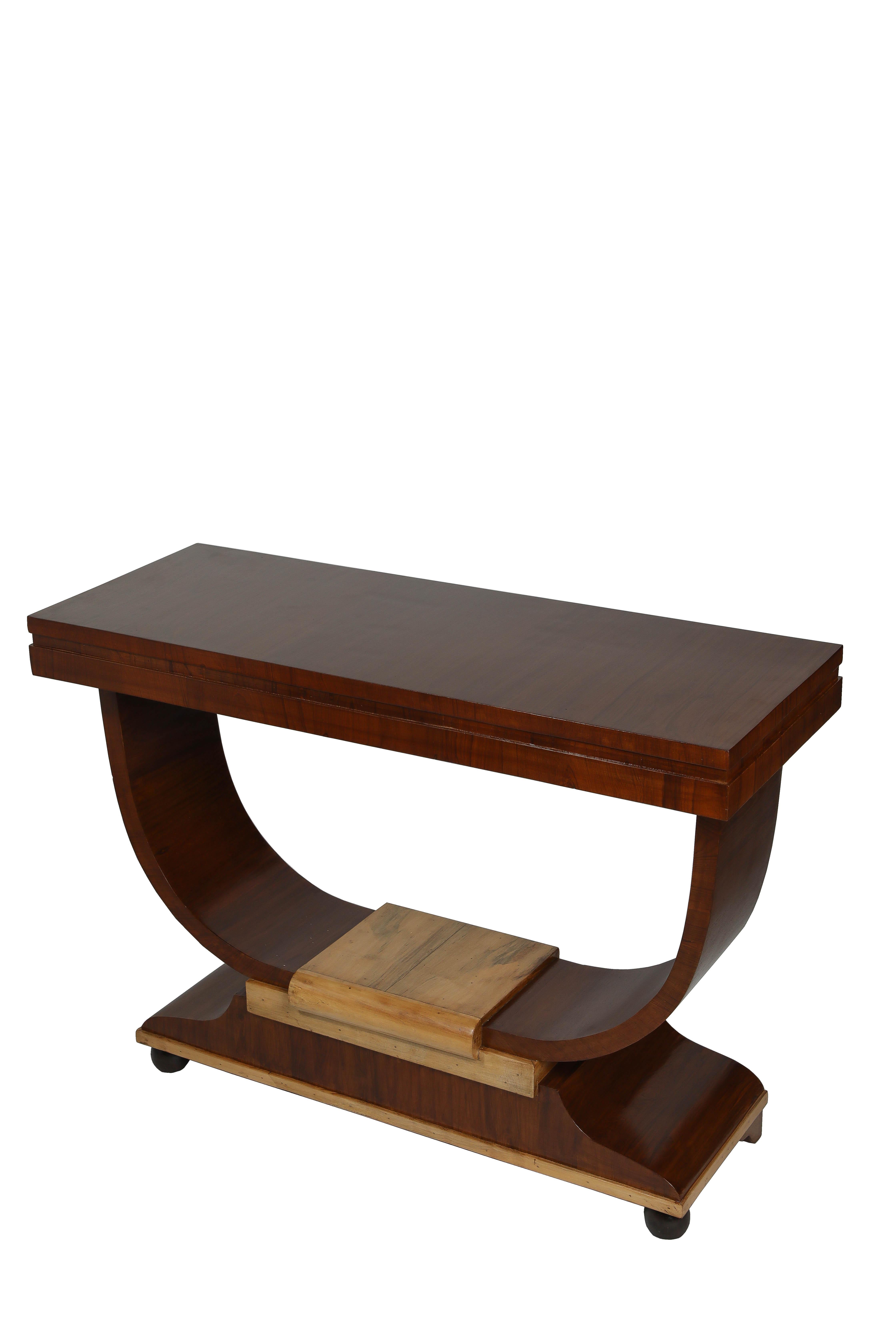 A handsome, French Art Deco console table with a lyre, U-shaped base.  The dominant wood is solid teak, with ebonized borders around the apron and the base; and a light spruce at the top of the base.  Refinished. Great to use in a dining room,