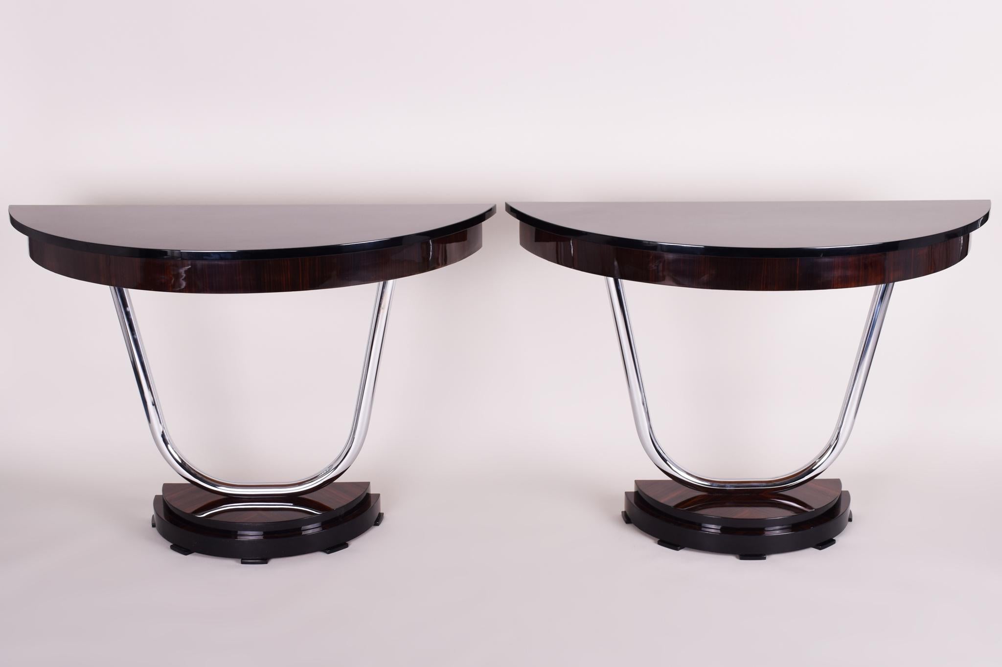 Pair of French Art Deco console tables. 
Completely restored, surface made by piano lacquers to the high gloss. 
Material: Macassar ebony veneer.