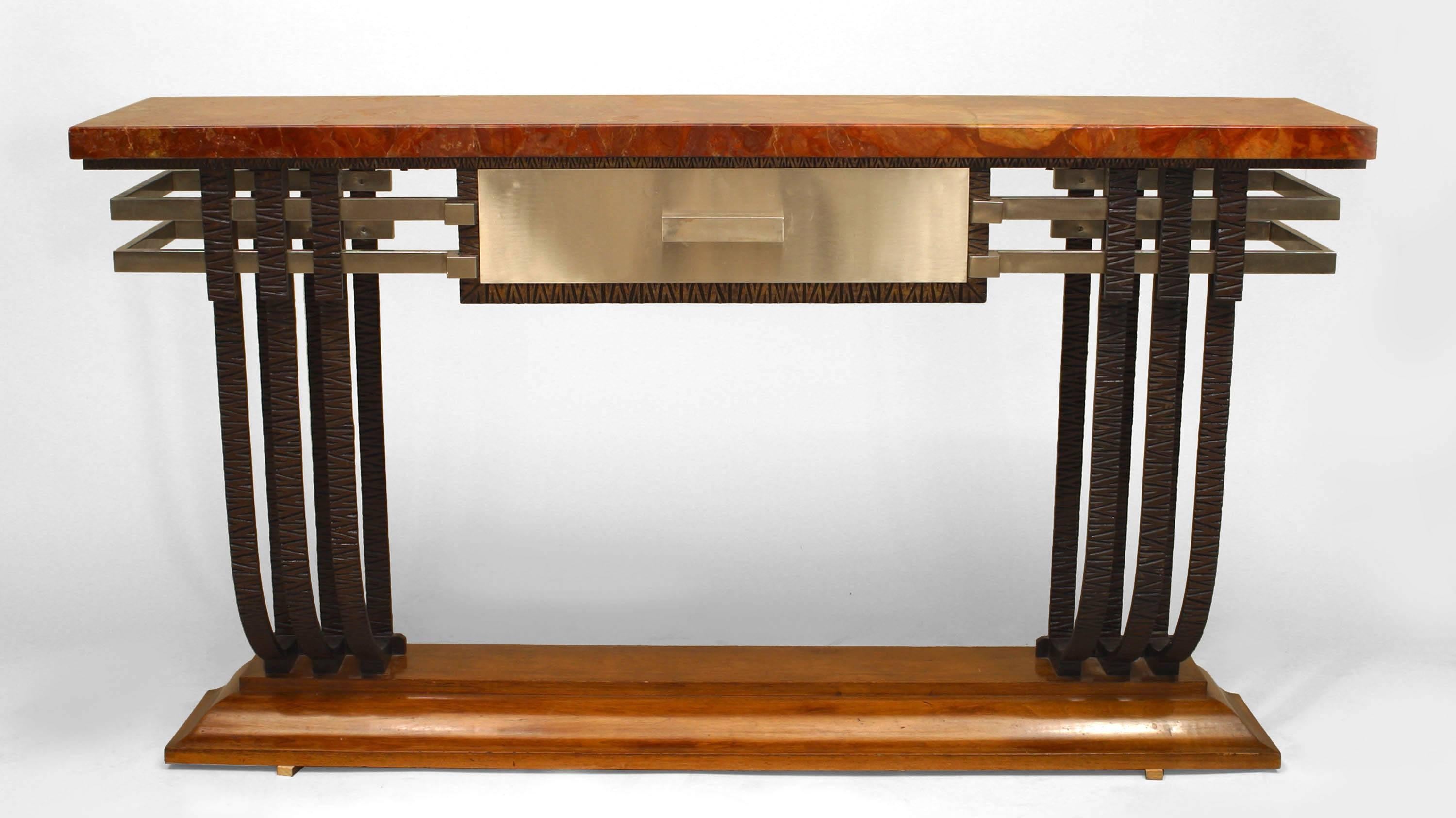French Art Deco iron & steel trimmed console table with a mahogany base supporting 3 iron scrolls on either side and a centered drawer under a rust marble top.
