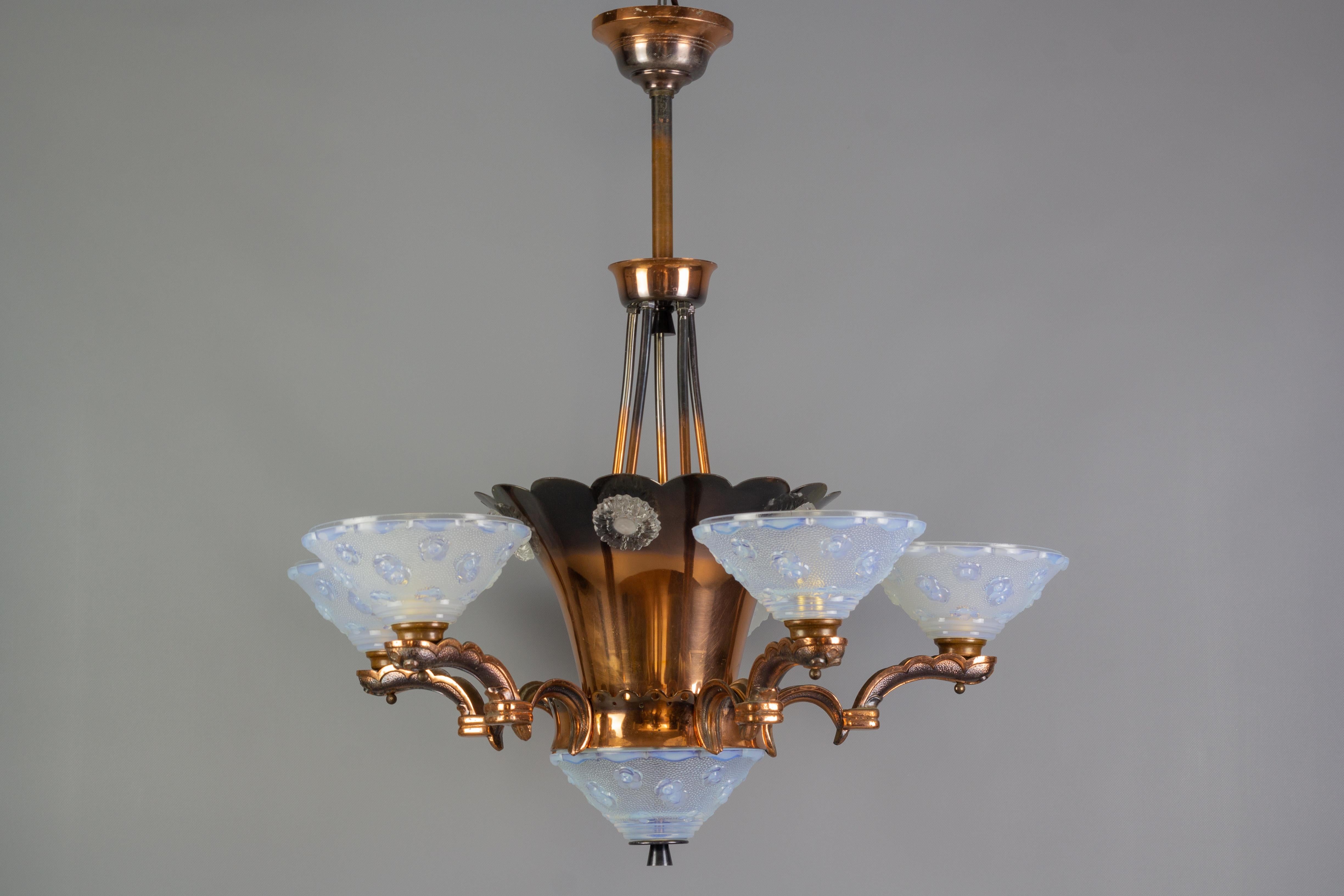 This magnificent Ezan chandelier, typically Parisian from the 1930s, is made of copper and glass with opalescent reflections. Glass signed Ezan France. The chandelier features five branches supporting opalescent frosted glass lampshades all