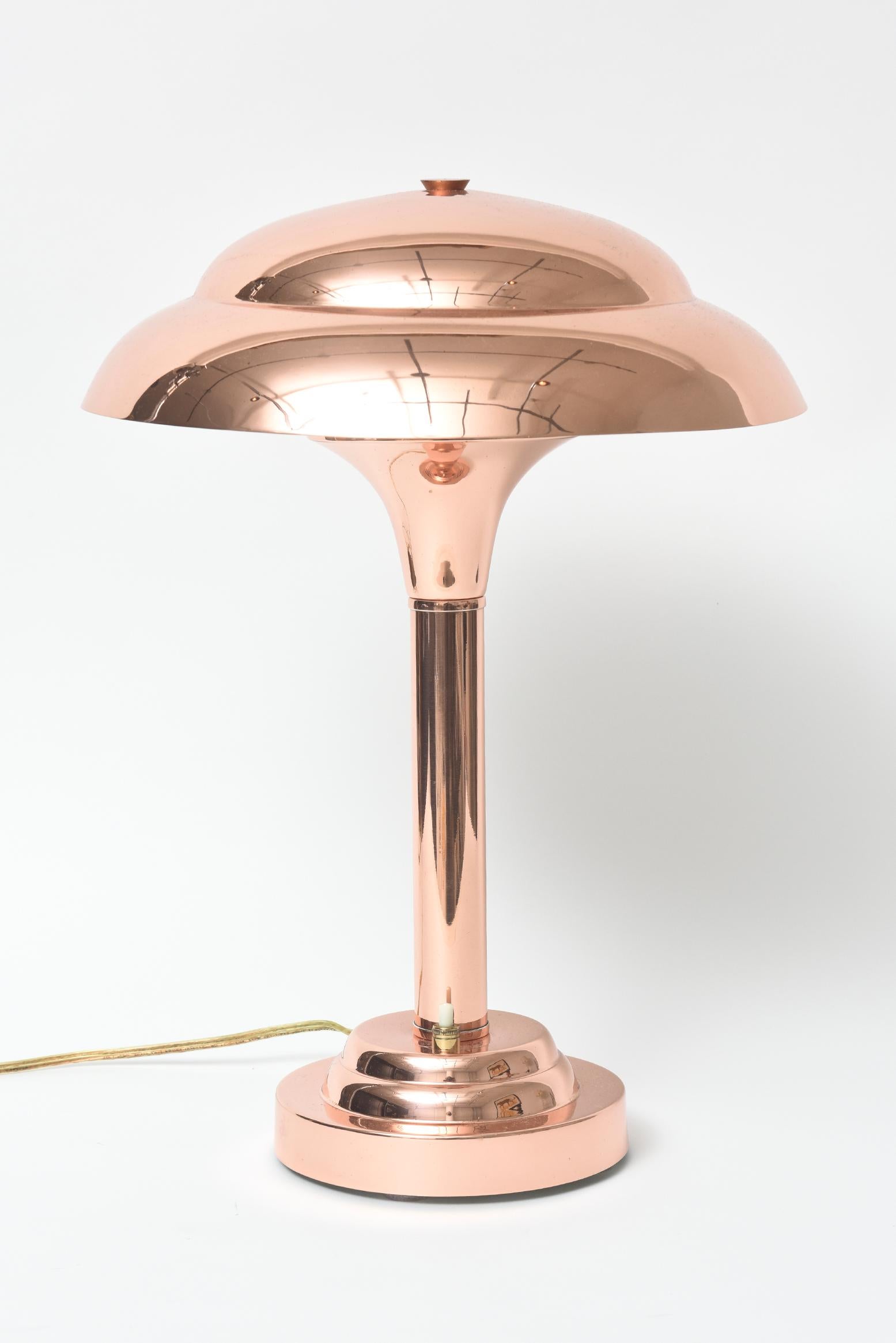 Stunning Art Deco copper lamp meant to sit on a desk or side table. It was manufactured in France during the 1920s to 1930s. The shade is a simple mushroom shape so that it reflects exactly the right amount of light to create the perfect atmosphere