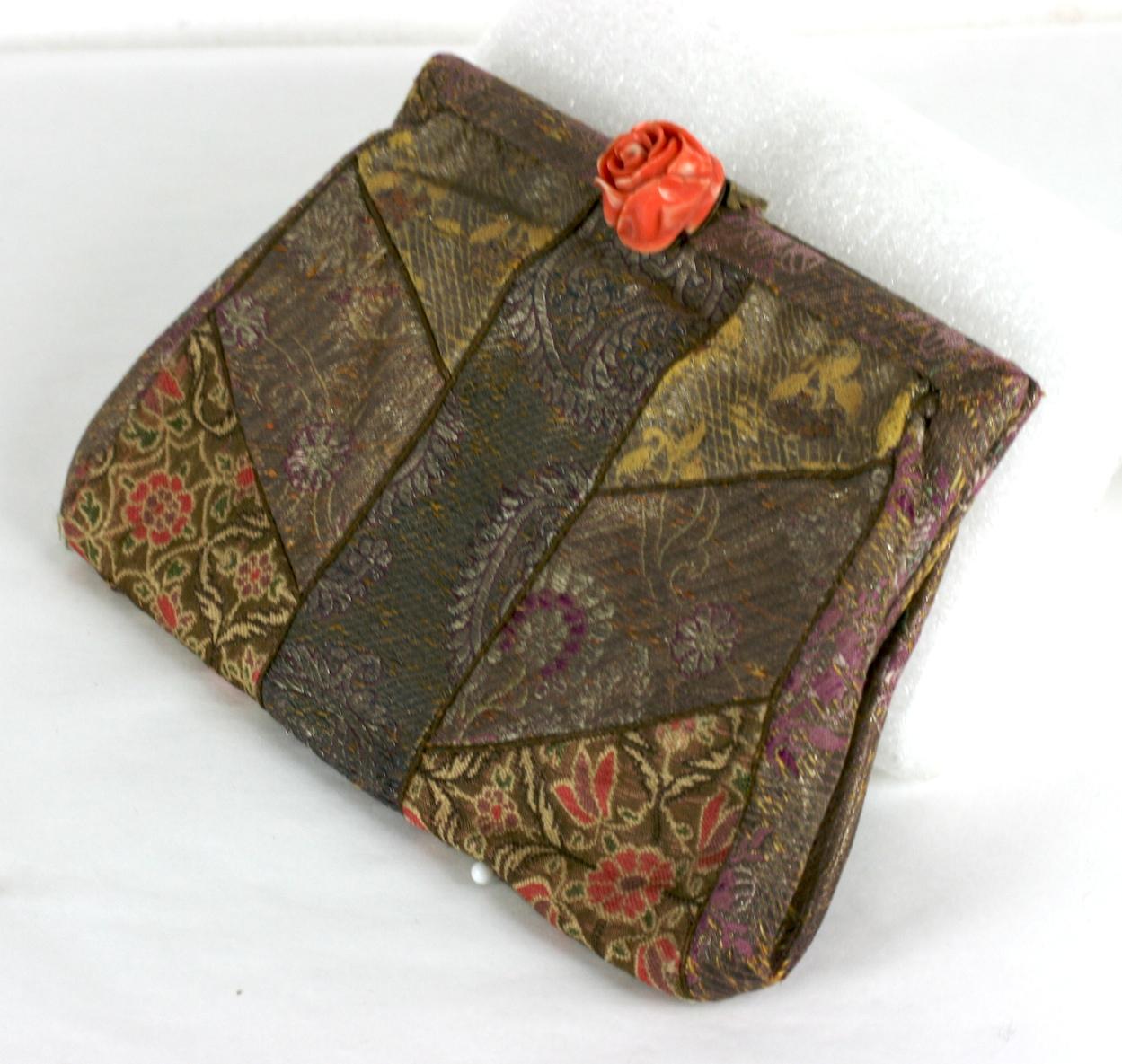 French Art Deco Anglo Indian evening clutch bag composed of a  patchwork of  19th century silk lame sari fabrics of various floral patterns with clasp of a genuine orange coral rose set in silver, Self wristband for dancing.
Excellent condition. 