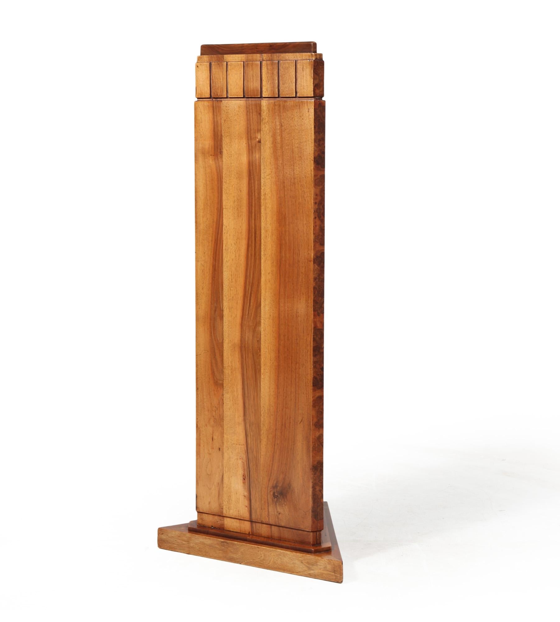An unusual solid walnut corner stand in triangular form for displaying a sculpture or vase the stand is very nicely made with detailing at the top and burr walnut running down the corners, the stand has been carefully restored and fully polished by
