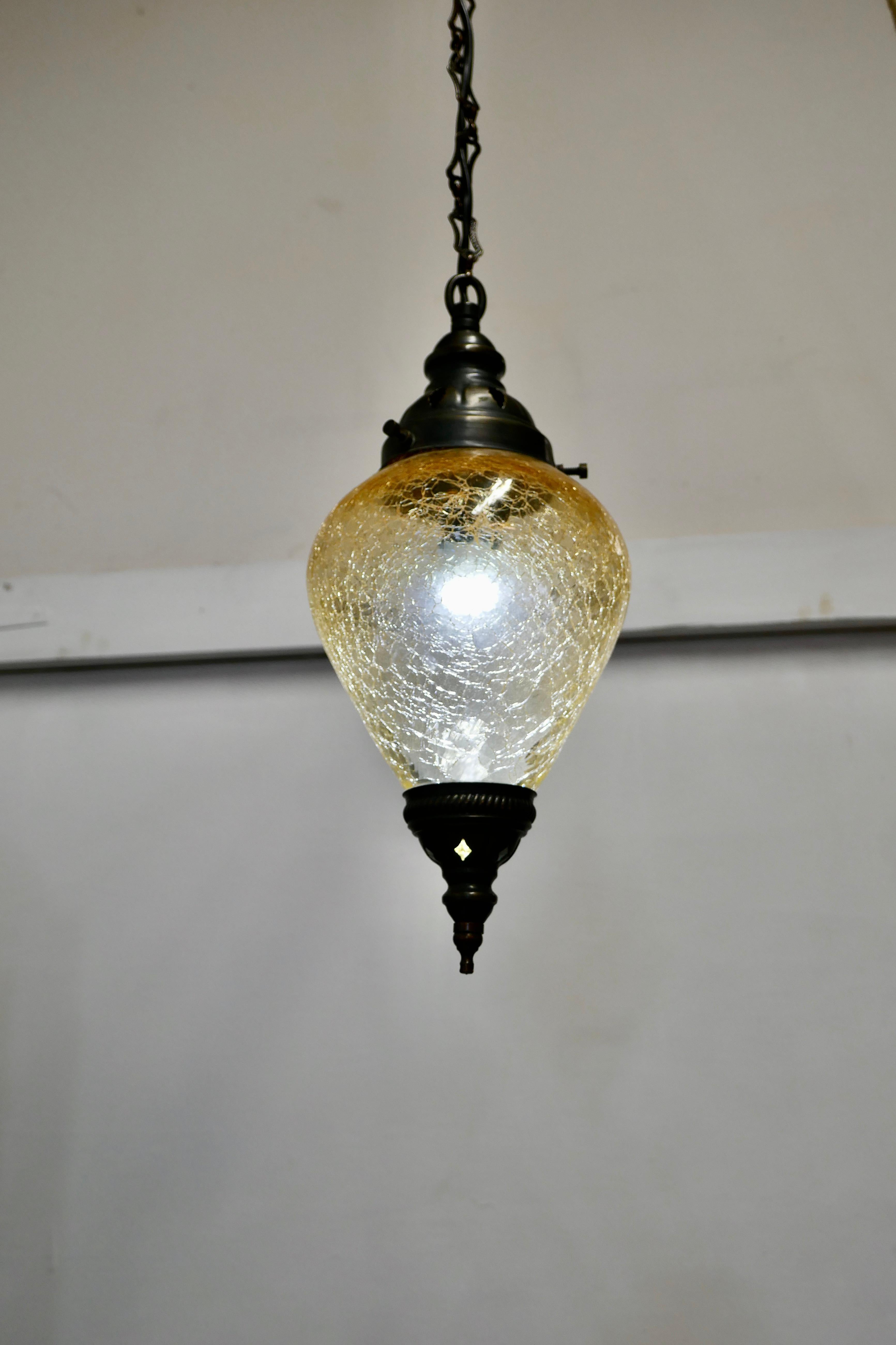 French Art Deco crackle glass hanging pendant light


Simple and beautiful, this crackle glass is a pear drop the shade is an amber color at the top fading to clear glass at the bottom, it has oxidized metal mounts, rose and chain
The light is