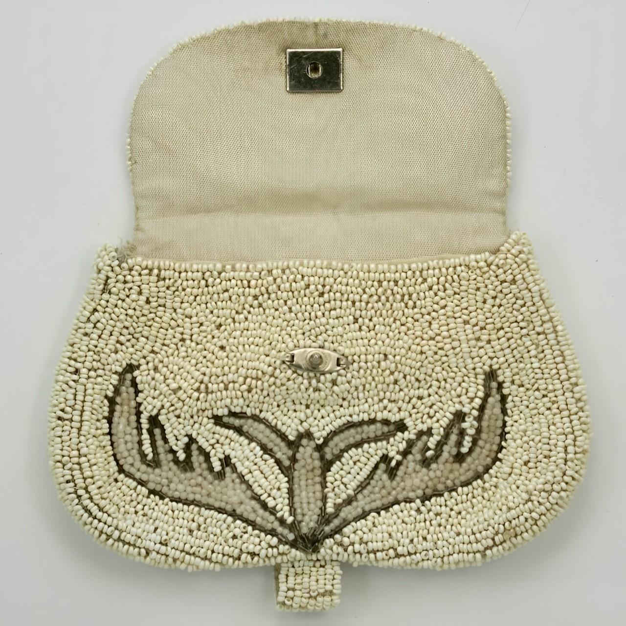 French Art Deco purse in neutral colours of creamy white, pale grey and shimmering dark grey beads. Measuring 14 cm / 5.5 inches by 9.1 cm / 3.58 inches. The purse closes with a popper. The cream moiré lining is in good condition and has a pocket