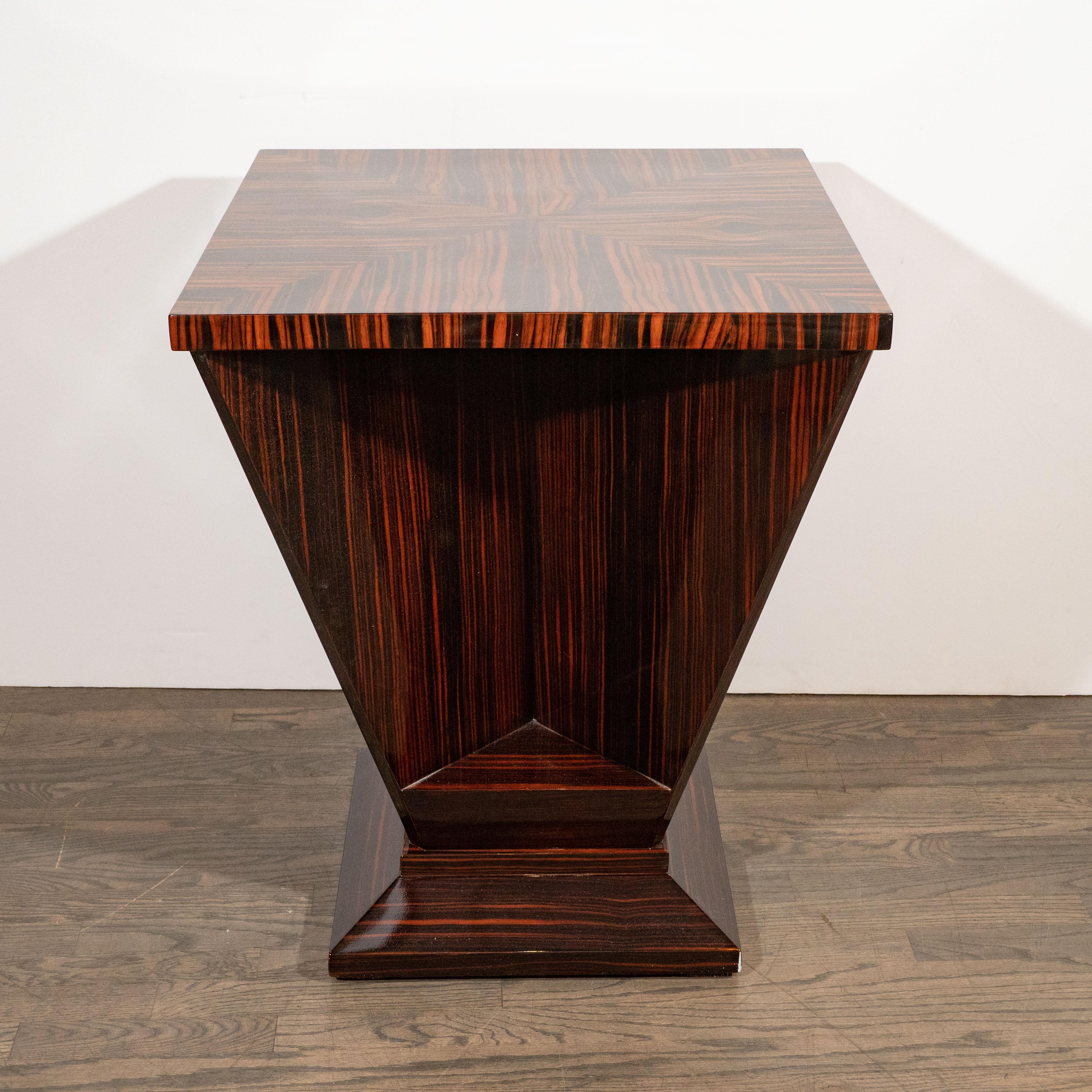 This dramatic occasional table was realized in France, circa 1930. It features a square top created from four triangular sections of bookmatched Macassar, which highlights the stunning natural grain of the wood, offering rich variegated tones and a