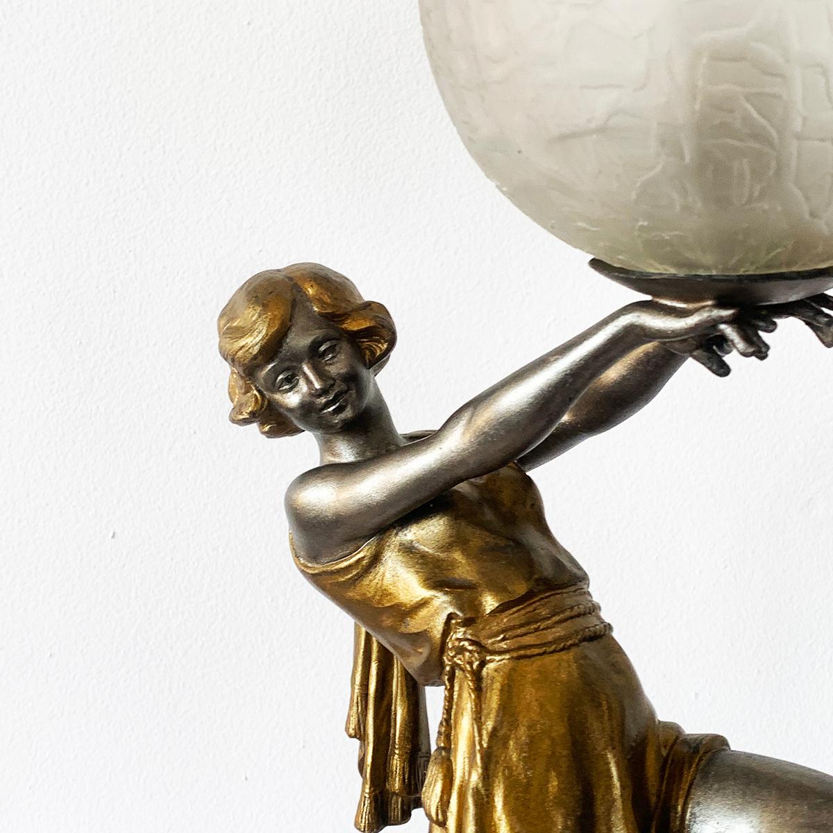 Art Deco French dancer lamp by Carlier. The dancer is holding an original glass brain shade in her hands on a finely detailed base. The original working wiring has been retained, France, circa 1920. Dimensions: Total height 52cm, marble base 9cm x
