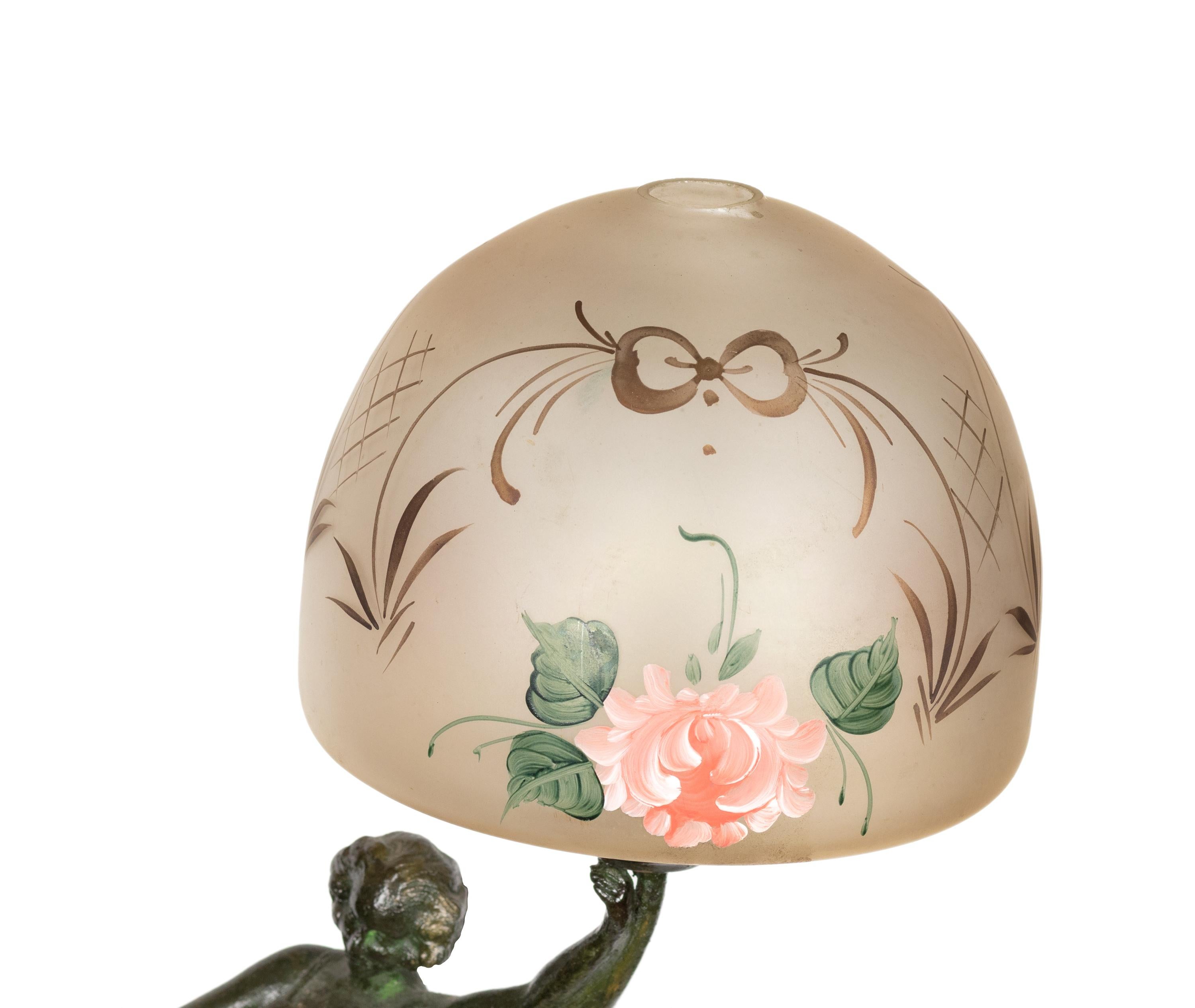 A french table lamp with a «Danseuse aux disques» statue, marble base and round polychrome glass lampshade

statue height: 22cm 
