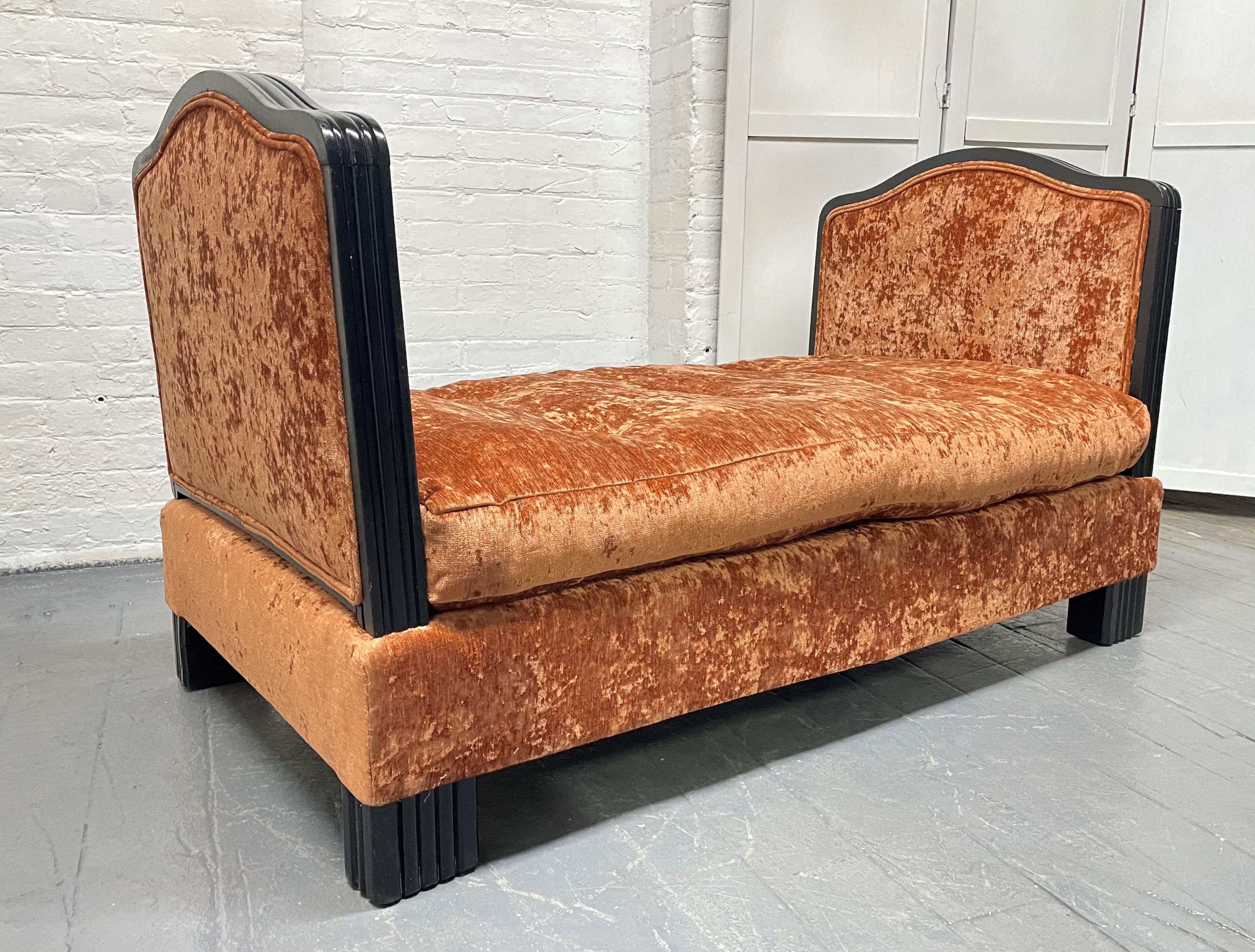 French Art Deco velvet daybed or large bench with removable ends. The daybed has a black lacquered trim and legs. The daybed has a loose cushioned seat.