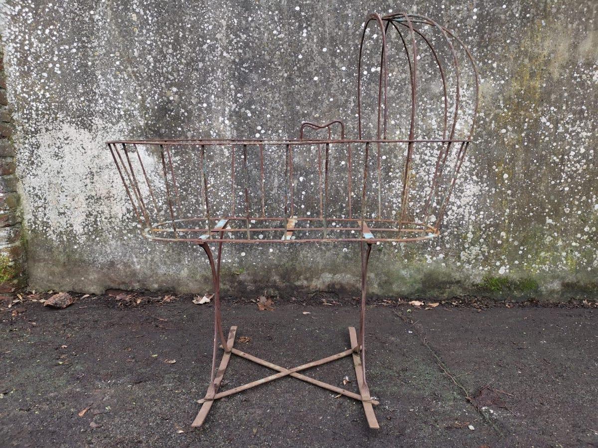 Good quality French Art Deco Decorative Iron child's cot or cradle with semi circular canopy above, and semi circular ends to the bed area with two handles to the upper edge, the whole on shaped supports and gentle sledge style rockers united by