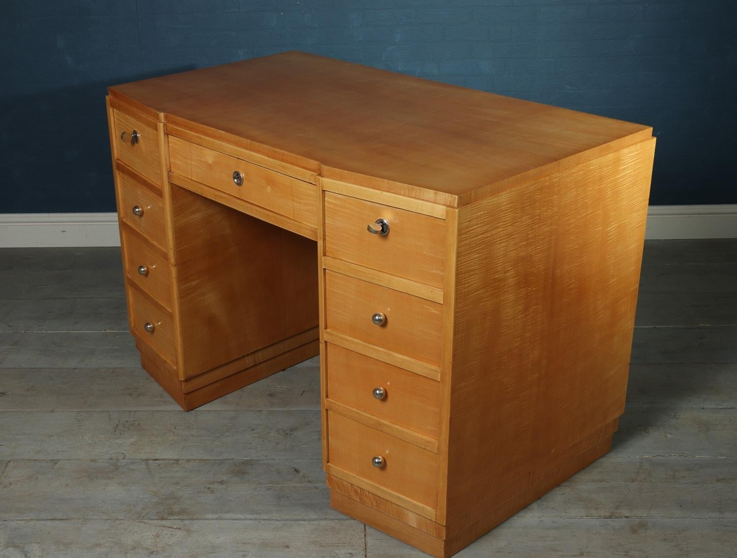French Art Deco desk in sycamore, circa 1930

A French 9 drawer sycamore desk produced in the 1930s, three lockable top drawers and all running smoothly fully polished and restored with a few age related marks
Age: 1930
Style: Art