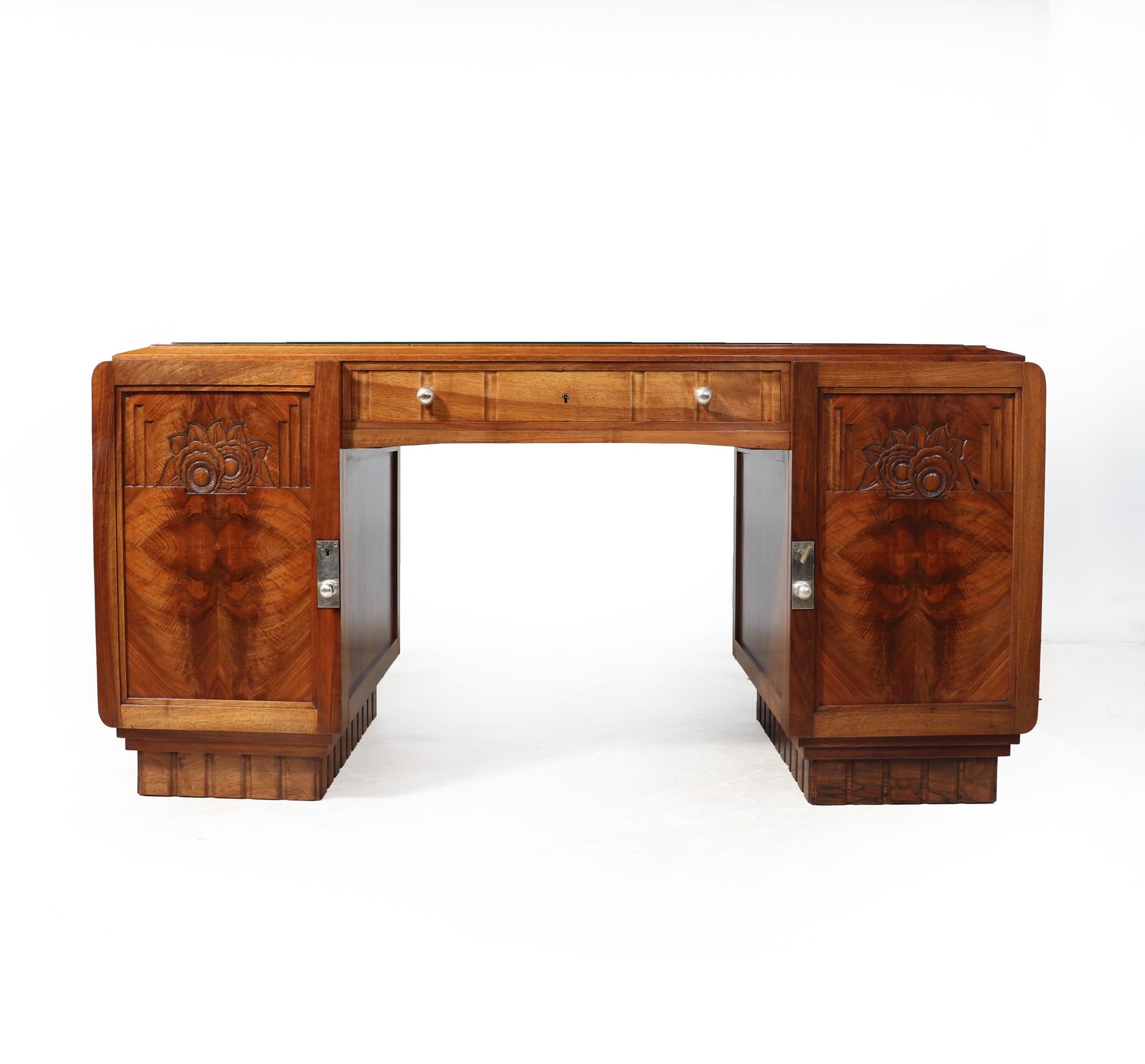 FRENCH ART DECO DESK IN WALNUT
An Excellent quality twin pedestal desk attributed to Paul Follot, in solid and figured walnut having a plate glass top and silver plated escutcheons, handles and key, the desk has one centre drawer two lockable doors