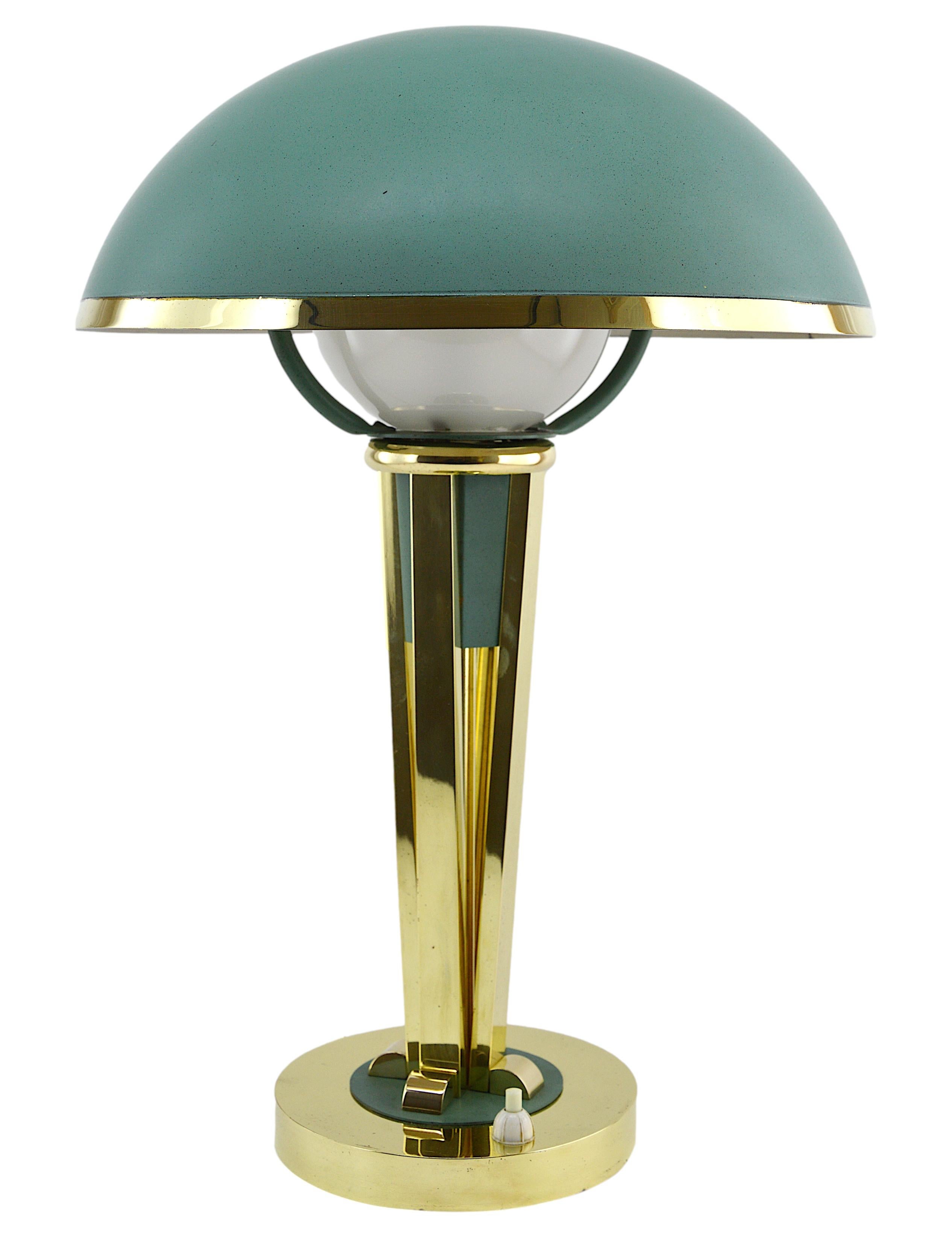 French Art Deco swiveling table or desk lamp, France, circa 1940. Brass and glass. Swiveling hemispherical brass shade painted granite like green. The paint is original. Round gilded brass base - The center in brass painted in the same way as the