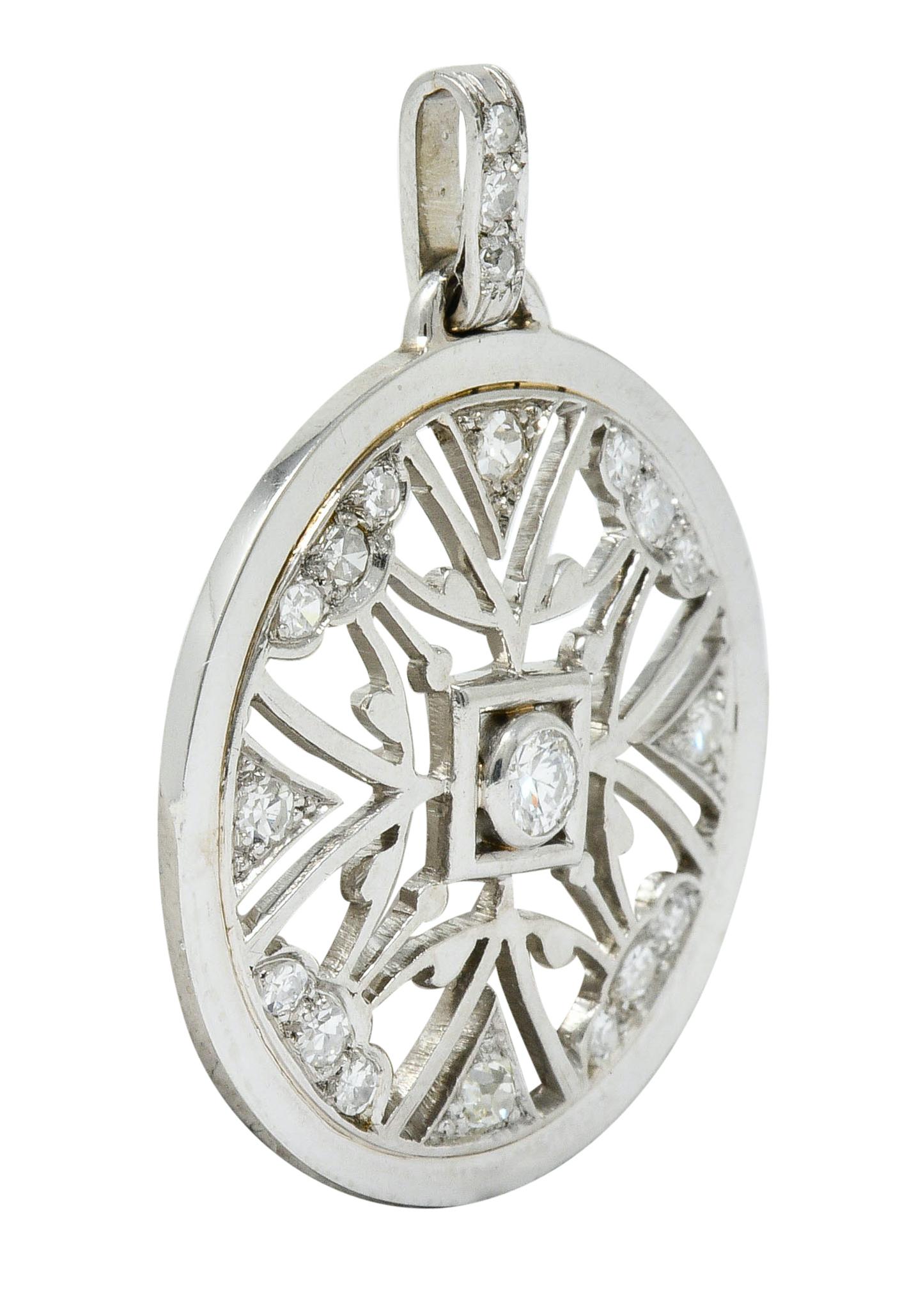 Circular pendant is pierced with a symmetrical geometric motif

Centering a round brilliant cut diamond weighing approximately 0.11 carat; I color with VS clarity

Surrounded by single and old European cut diamonds weighing in total approximately