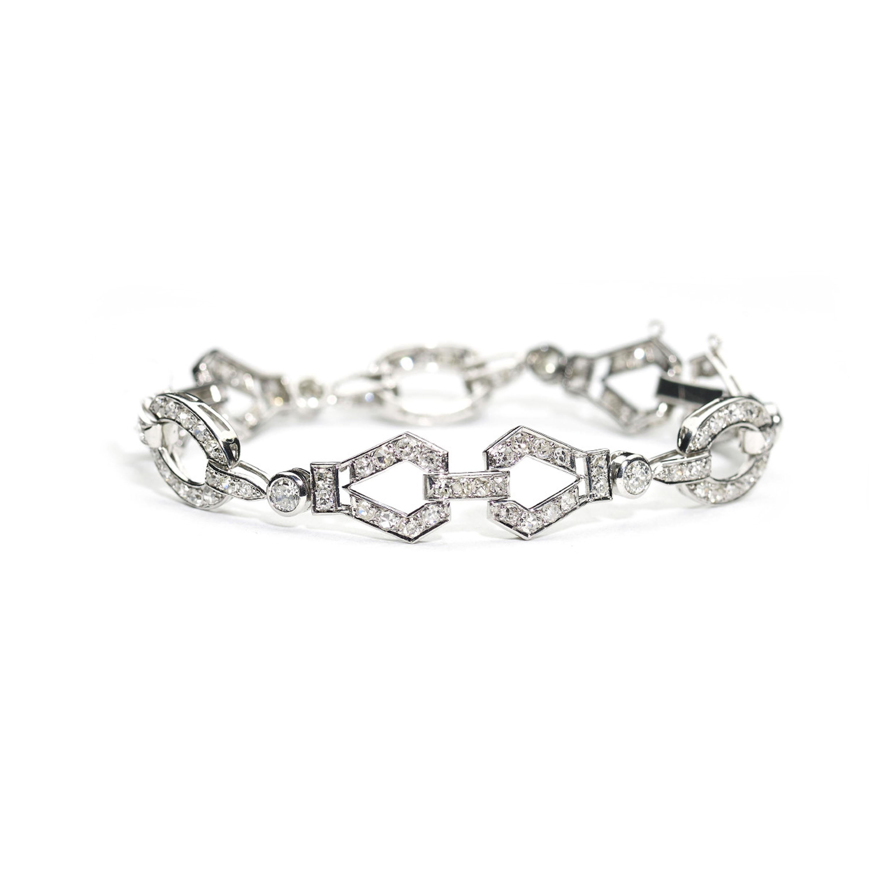 A French, Art Deco diamond bracelet, with a geometric design, set with round brilliant-cut and eight-cut diamonds, mounted in platinum, with French dog's head marks for platinum, with a white gold clasp, circa 1930. Estimated total diamond weight