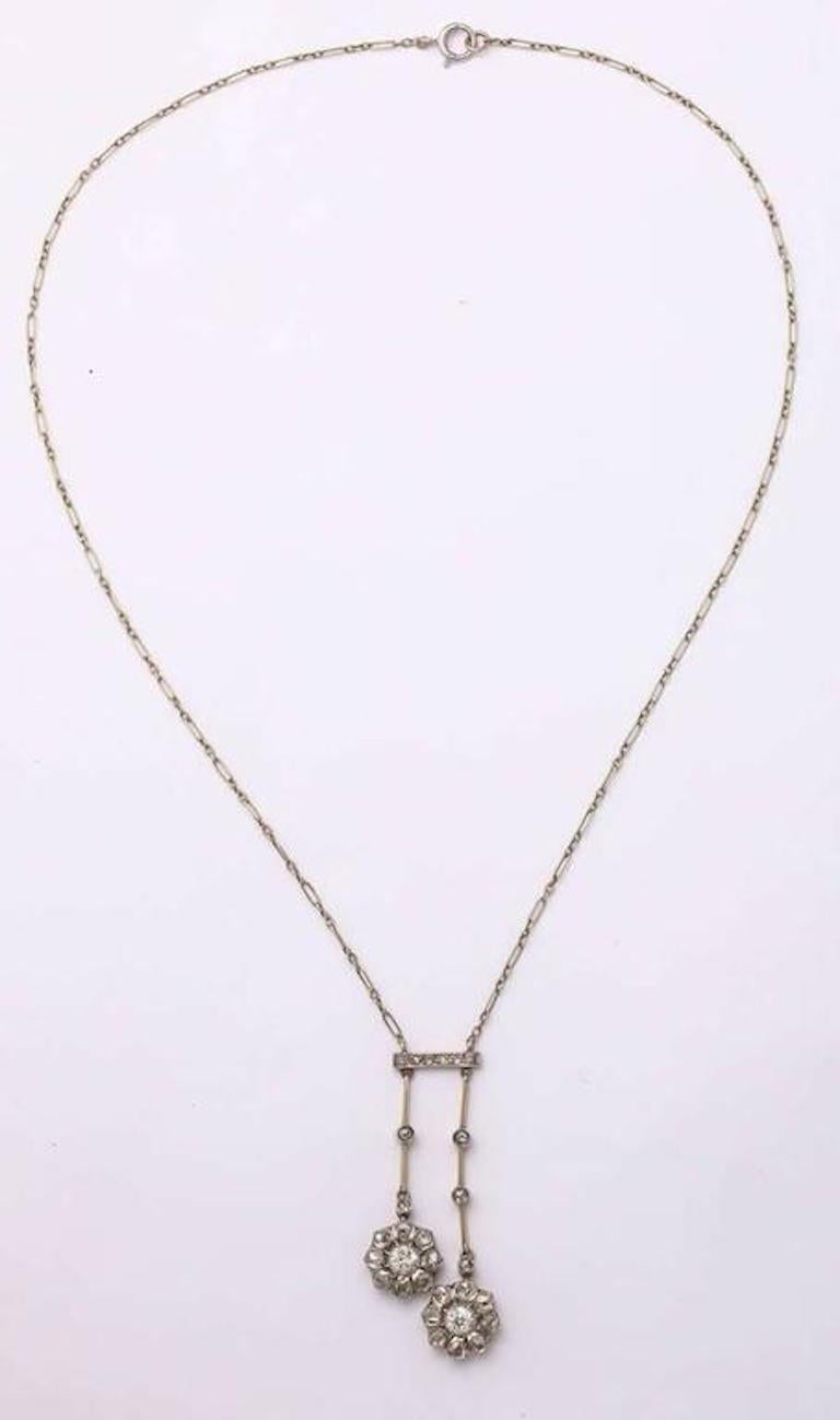 A stunning original Art Deco french diamond neglige consisting of 3 cts of rose diamonds set in a neglige of two floral drops with smaller diamonds along the chain and bar set in platinum along a platinum and linked chain.