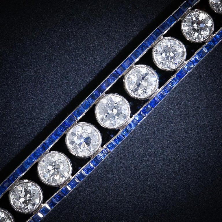 An absolutely stunning example from the high-Art Deco period, circa 1925. This fabulous sparkling platinum bracelet features twenty-six bright-white European-cut diamonds, together weighing ten carats, which gently graduate between two rows of