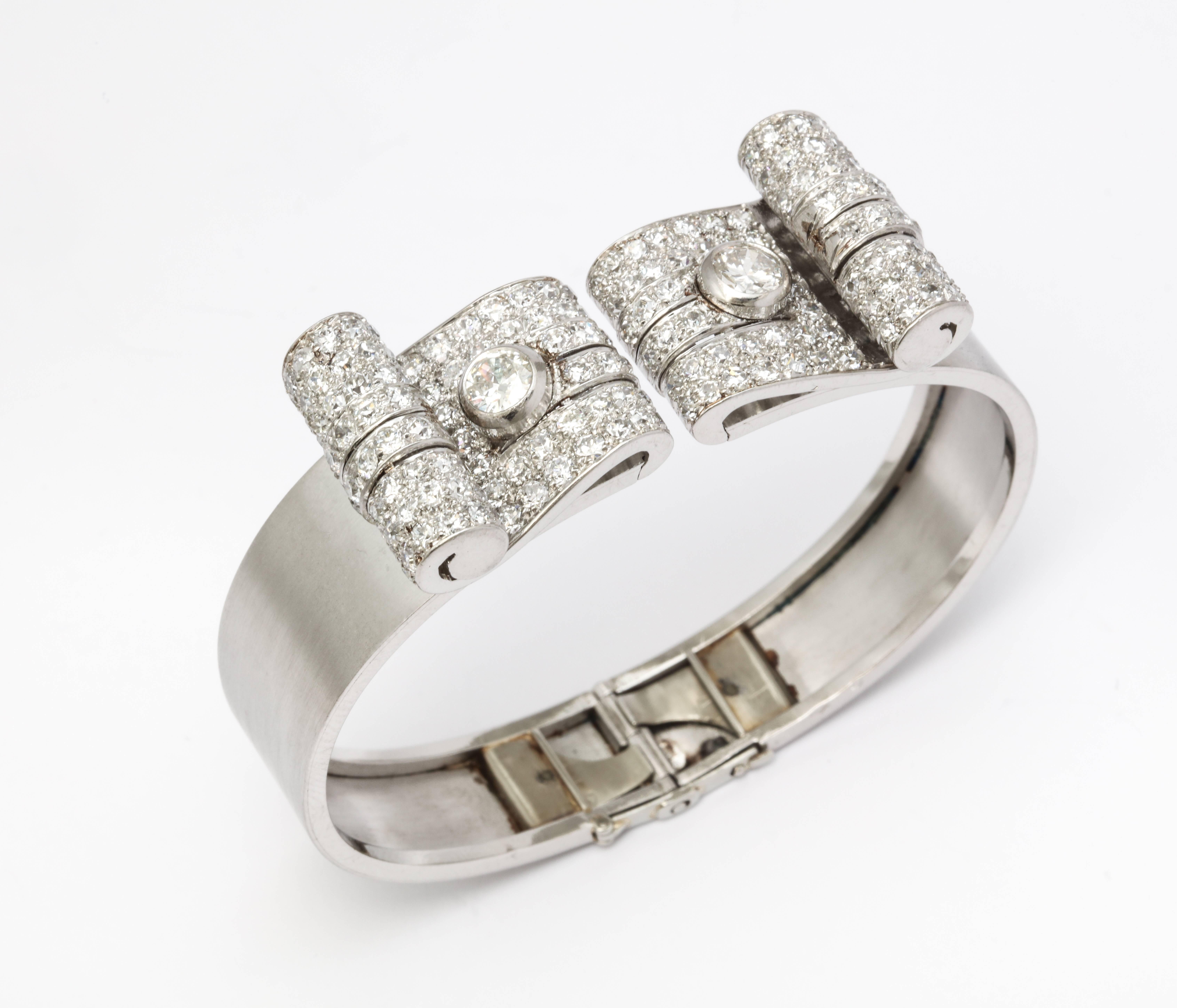 French Art Deco Diamond Bangle

With French hall marks and unidentified Maker's Marks

Set in matte Platinum

Made in Paris circa 1920

Circumference: 6.75