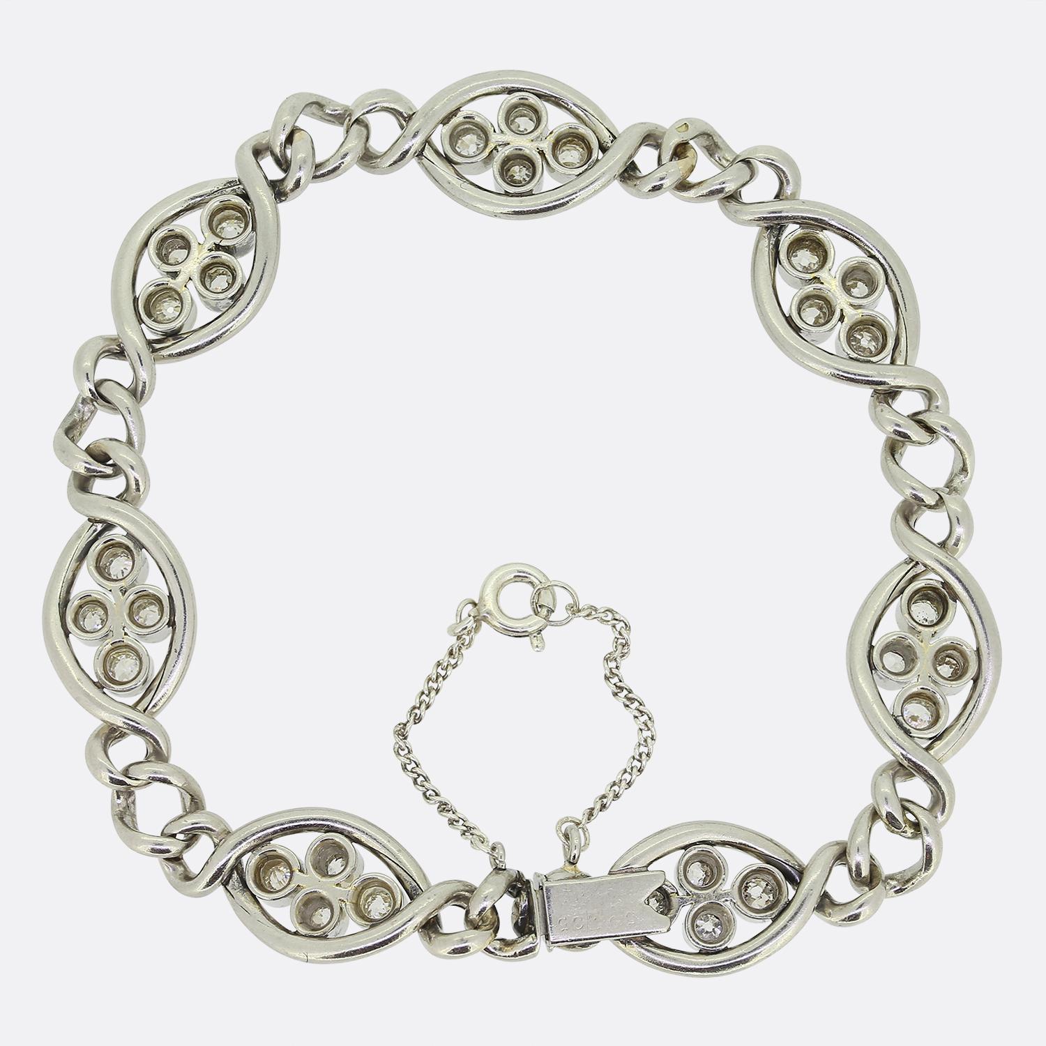 Here we have a gorgeous antique diamond chain bracelet. This French piece has been crafted from platinum during the pinnacle of the Art Deco movement and showcases seven open elliptical sections containing four individually bezel set round faceted