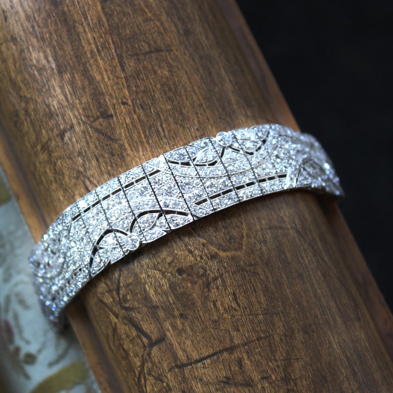 Art Deco Diamond Panel Bracelet, French, ca. 1920s

A beautiful and striking Art Deco bracelet from the 1920s made in France. The panelled design follows six arched floral motifs. The bracelet has ca. 20 carats of old European cut diamonds (ca.