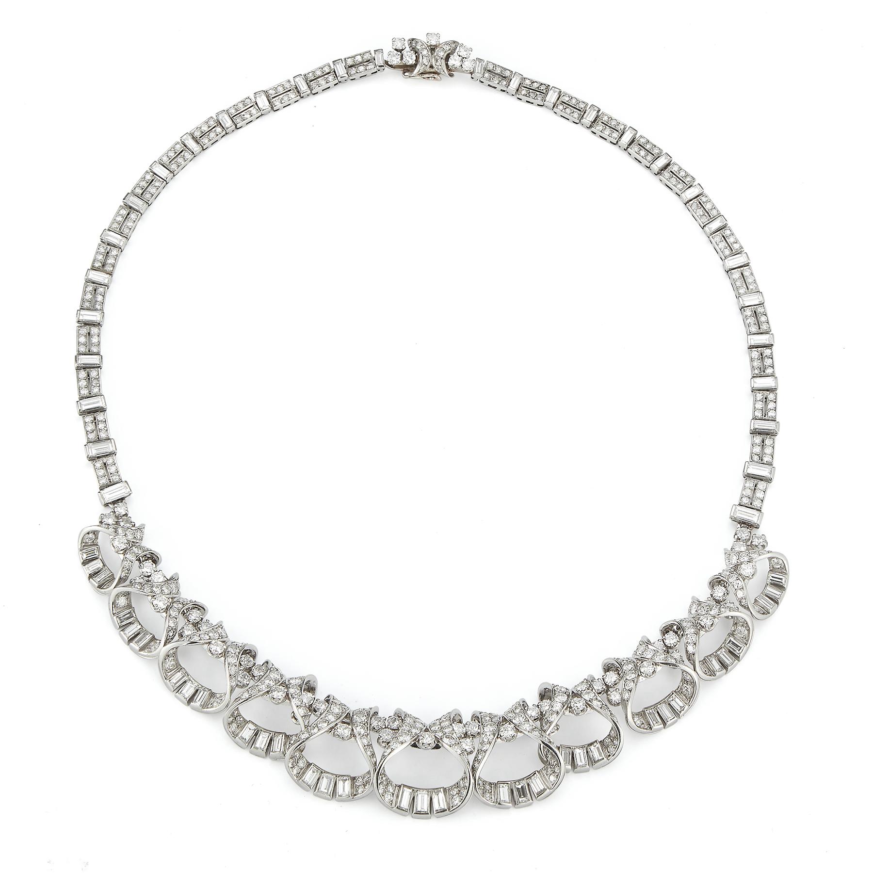 French Art Deco Diamond Necklace

Approximately 24 carats total diamond weight

Round & baguette cut diamonds
396 small round cut diamonds ,53 larger round cut diamonds & 63 baguette cut diamonds set in platinum

Made Circa 1920

Measurements: 16