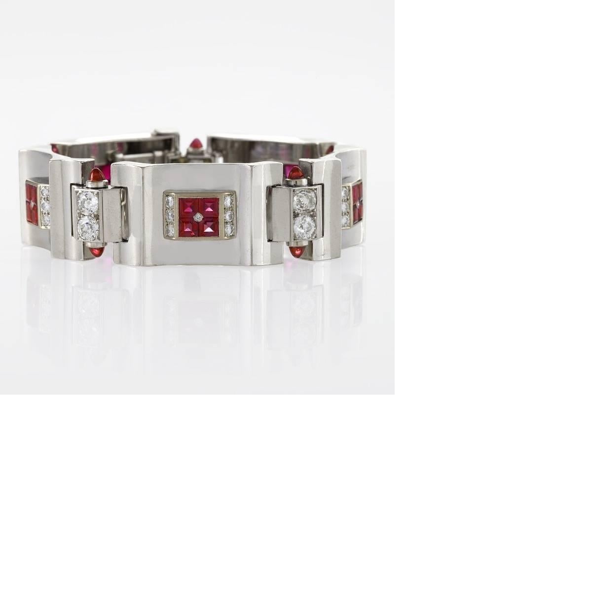 A French Art Deco polished platinum and 18 karat gold bracelet with rubies and diamonds. The bracelet has 20 square-cut rubies with an approximate total weight of 5.00 carats, 10 cabochon rubies with an approximate total weight of 1.00 carat, and 45