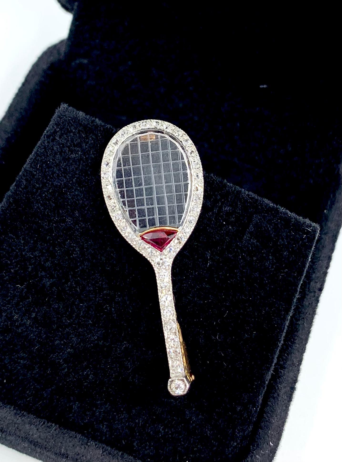 Attributed to Van Cleef & Arpels, signed with French Makers Mark for Pery, 
Albert Pery is listed as having worked with Van Cleef & Arpels circa 1925,

Art Deco period diamond, ruby and carved rock crystal platinum and 18K gold tennis racquet