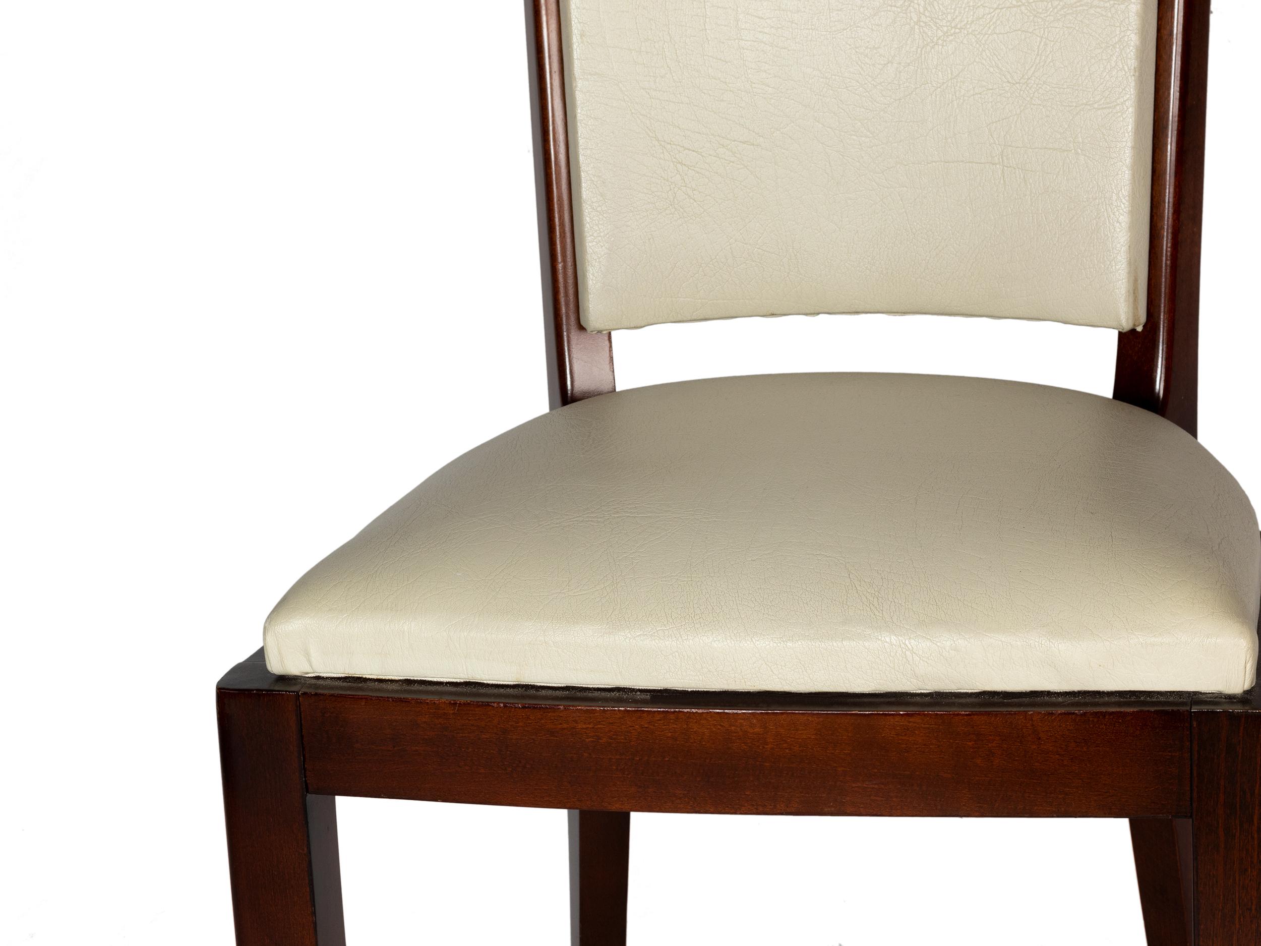 A very elegant dining room chairs in white vinyl and polished wood finish.  In excellent condition, recently revised by an expert ebanist.

