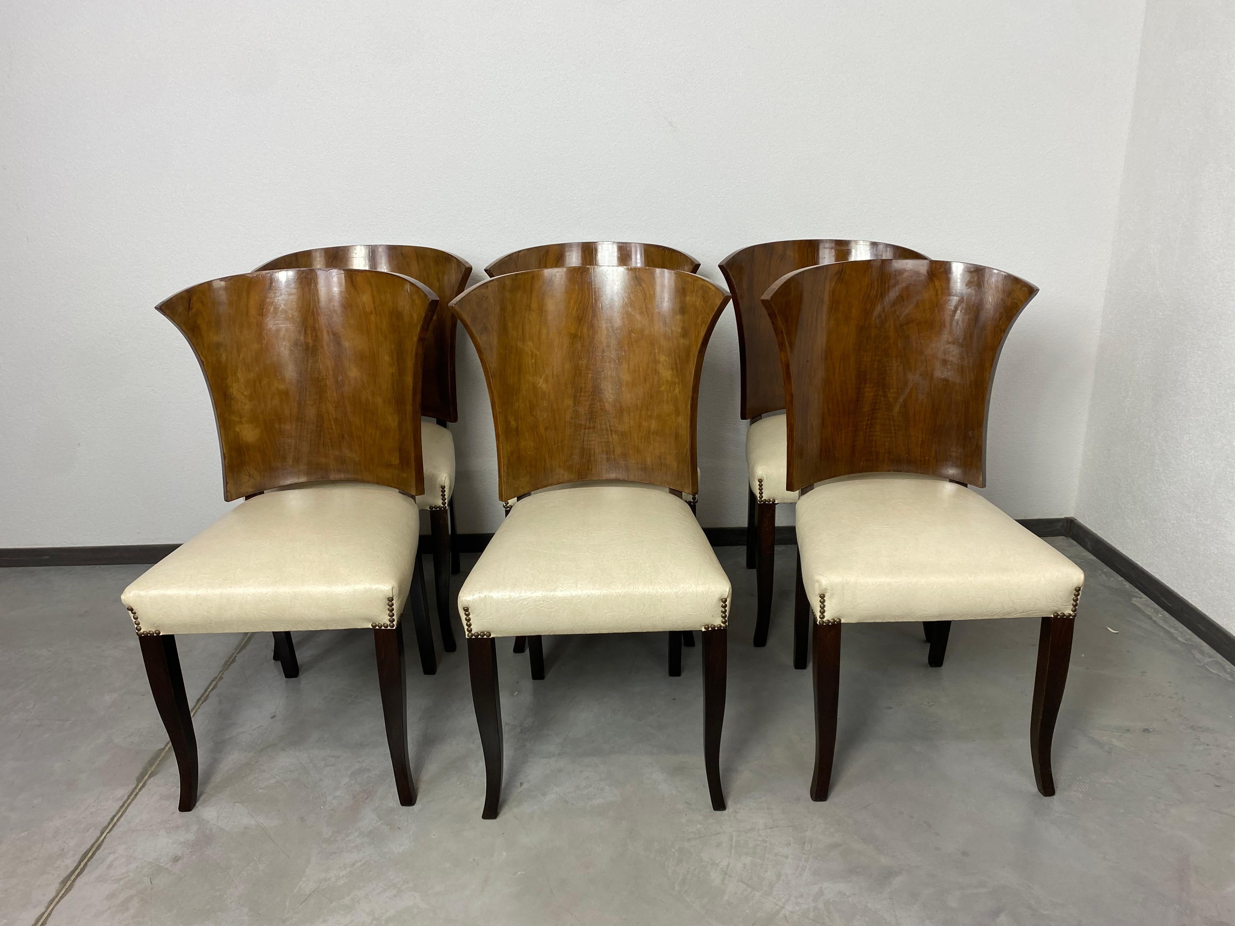Set of 6 large art deco dining chairs from France in original vintage condition with signs of use. Walnut well designed backrest, white leather seats.