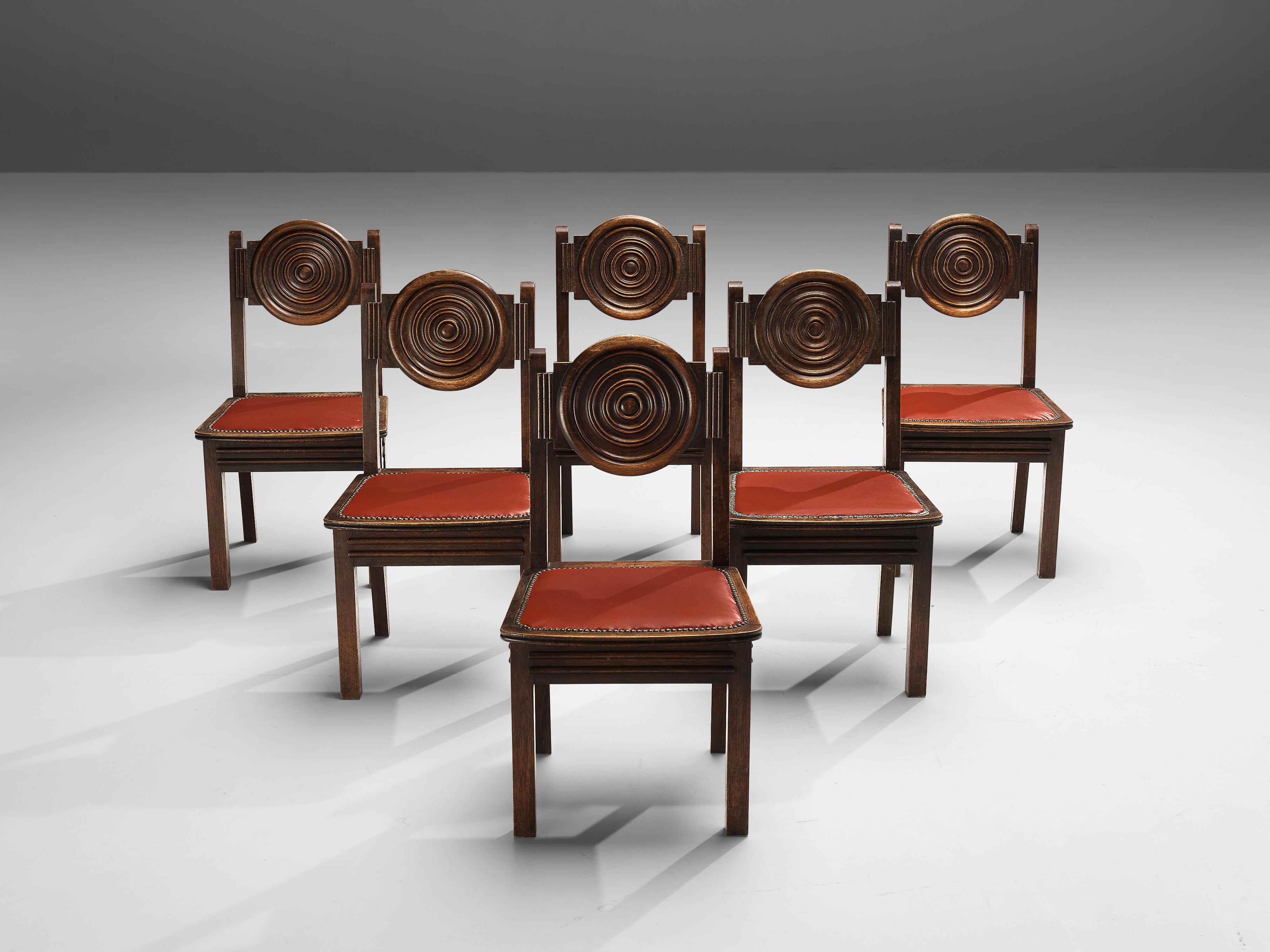 Art Deco dining chairs, stained oak, leatherette, brass, France, 1940s

With their round backrest this set of six French dining chairs catches the eye. Carved rings emphasize the circular form and create a rhythmic relief. But not only the backrest