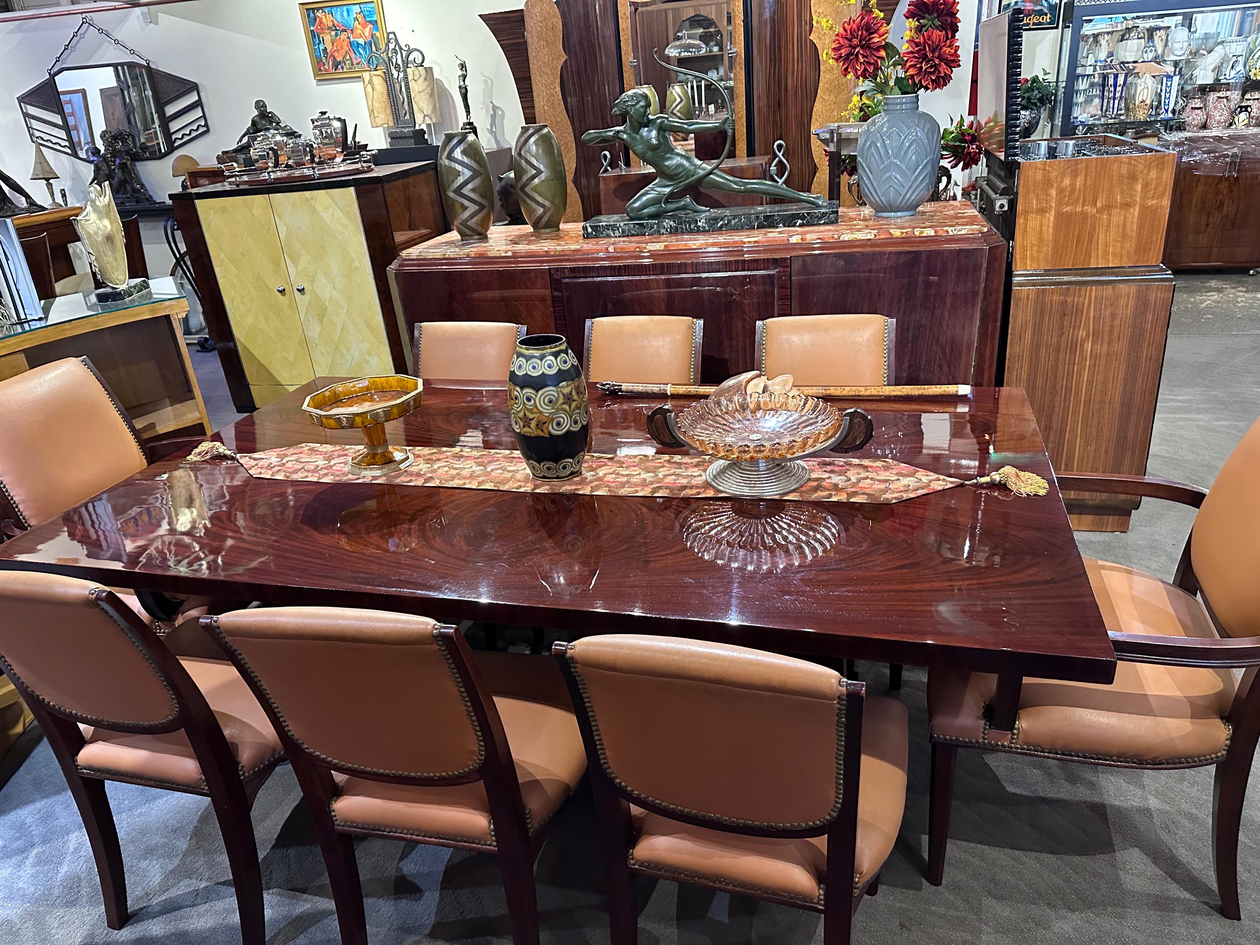 French Art Deco Dining Room Suite featuring 8 chairs and 3 matching side pieces boasts one of the most remarkable marble tops ever seen, fitted flawlessly with beveled edges. Restored to its original glory in luxurious rosewood, this suite
