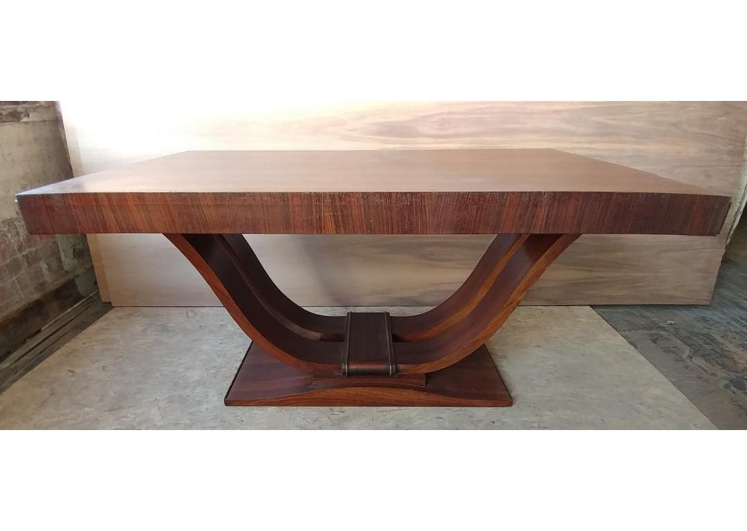 This stunning French Art Deco harp shape table from 1935 is part of a complete Dining room set. Can be used for dining or as an impressive desk or a small conference table. Constructed from solid wood with mahogany veneers. The top has two