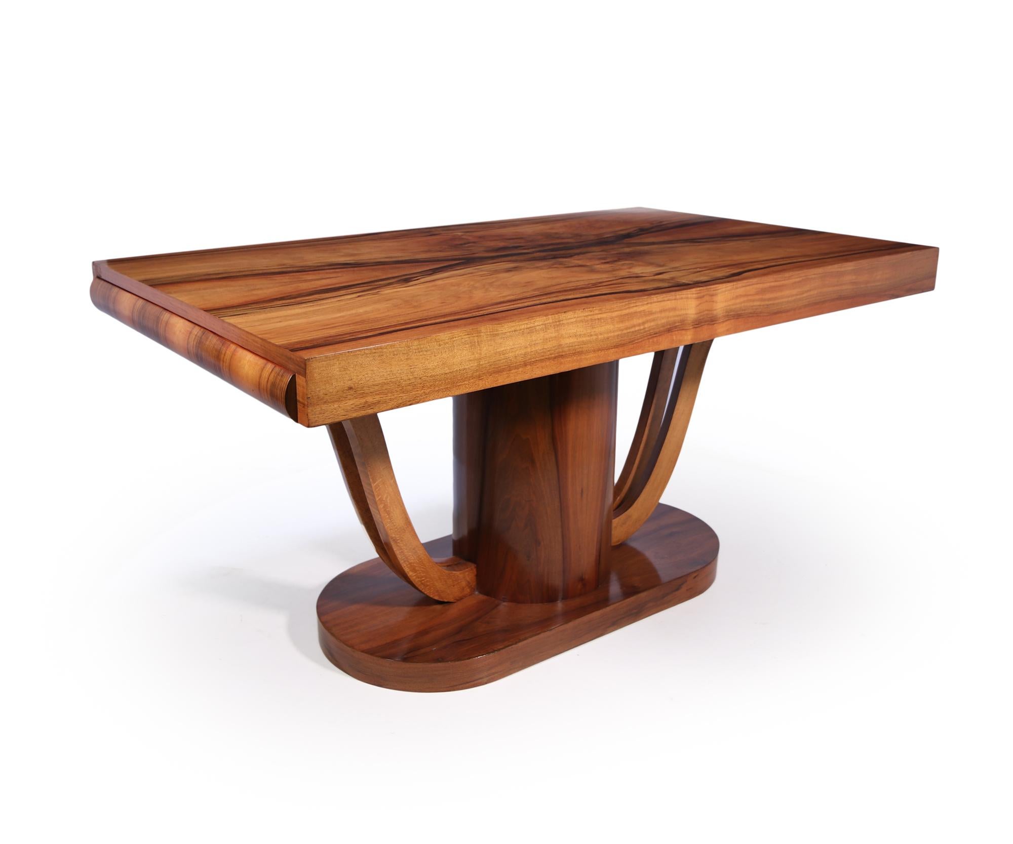 A walnut dining table on a central pedestal base good sized top with drawers in either end

the table has been restored where necessary and fully polished by hand

Age: 1930

Style: Art Deco

Material: Walnut

Origin : France

Condition: