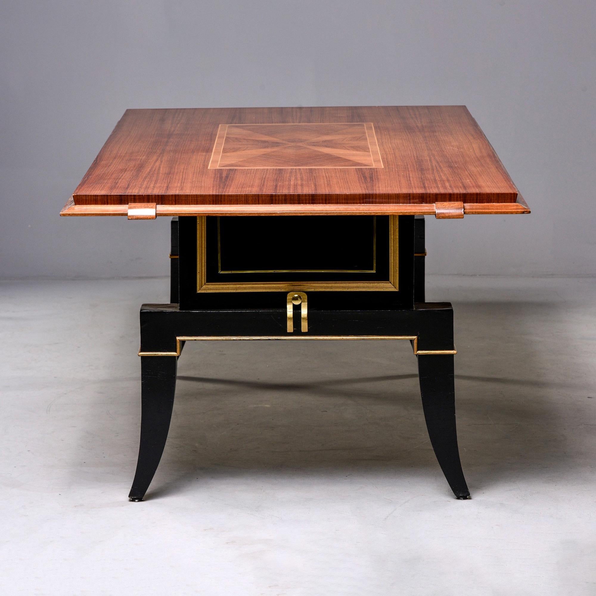 French Art Deco dining table features a polished top with inlay details, beveled edge and contrasting black and giltwood base circa 1940s. Solidly constructed. Unknown maker.

Apron height 28”.