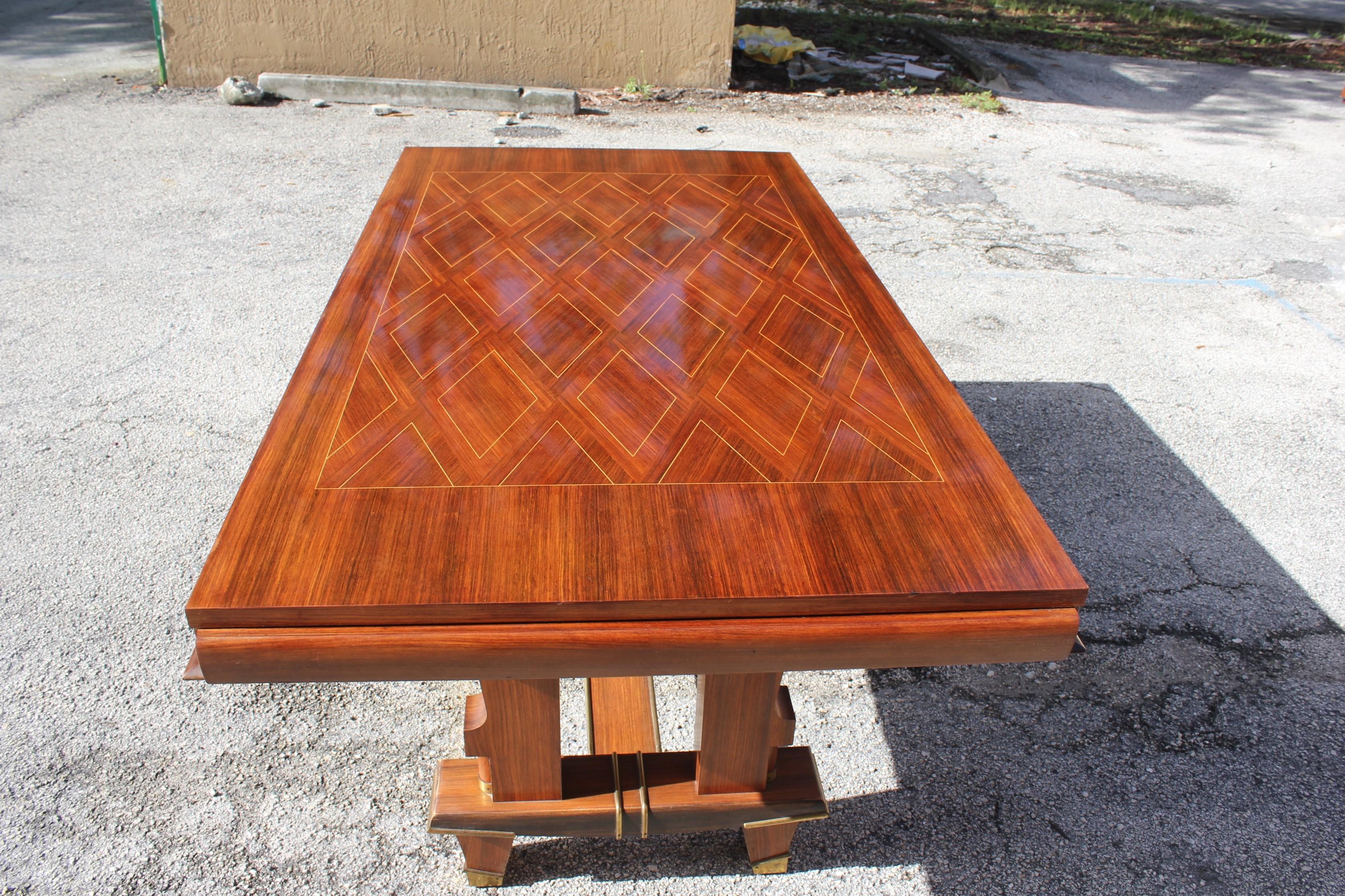 Beautiful French Art Deco dining table or desks and writing tables
rosewood with diamond inlay marquetry by Jules Leleu style. The top of the table has geometric design. The base of the table have bronze hardware accents, please note these dining