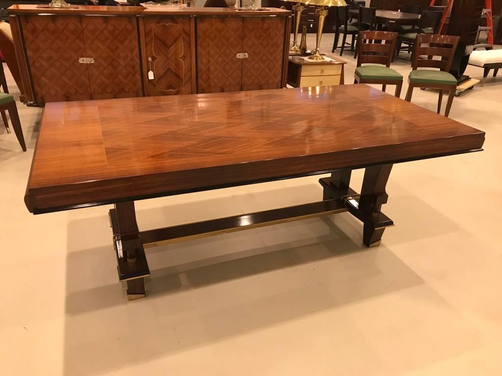 Stunning French Art Deco high polish dining table with diamond inlay marquetry. The top of the table has geometric design. Having ebony accents.