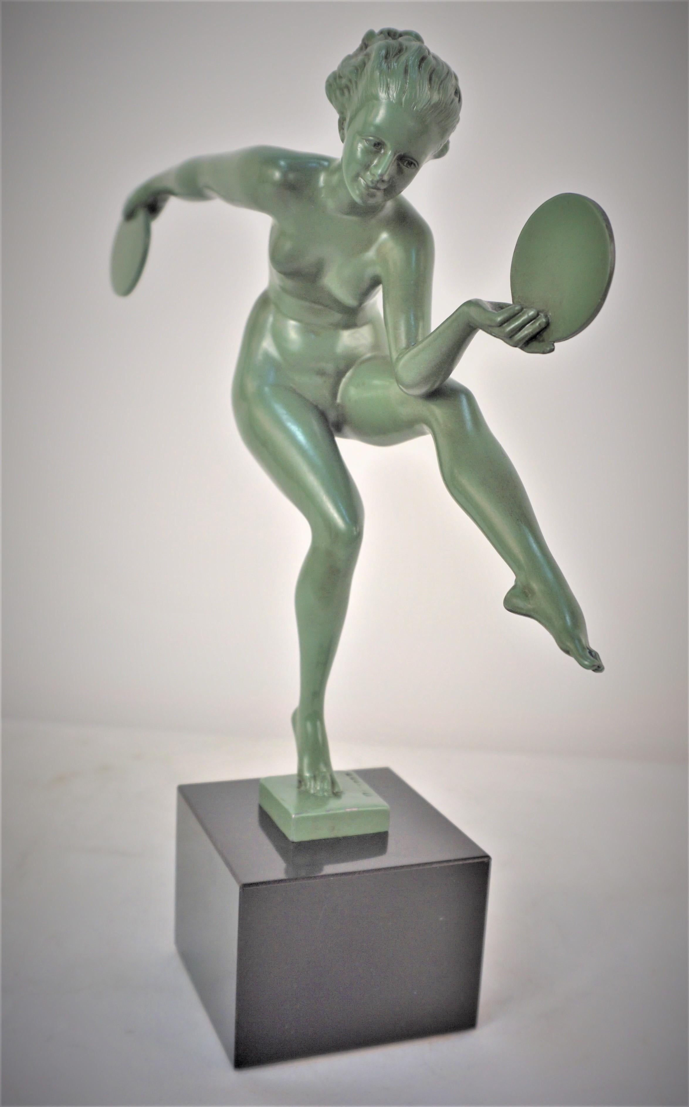 Graceful sculpture of a dancer with disk in green finish standing on black marble by Alexandre-Joseph Derenne for Max Le Verrier.