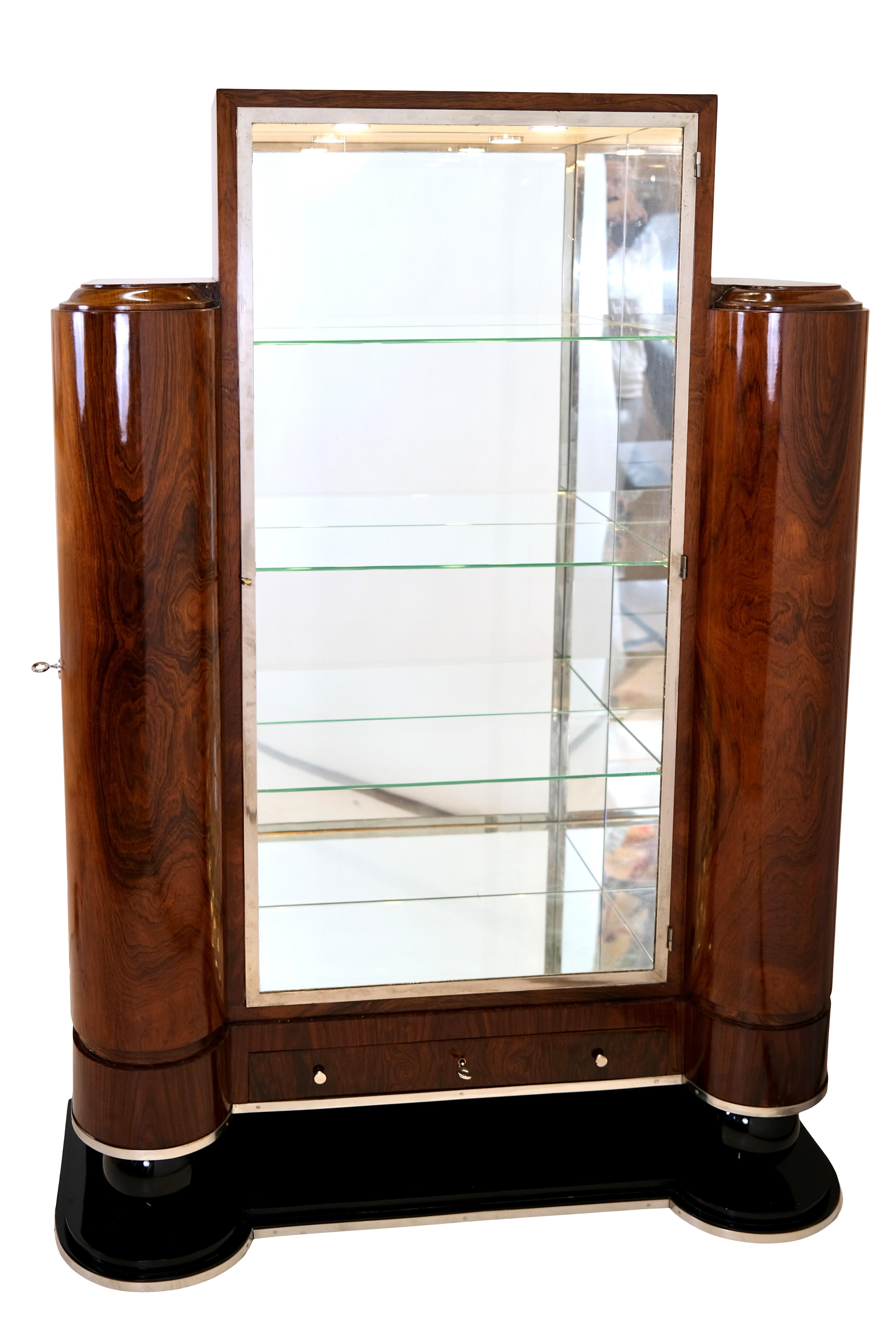 Display case with columnar side compartments

probably stained ash, hand polished shellac
base supplemented
lighting in the main element with switch
lighting in the side compartments with motion detectors and battery, added
Inside freshly