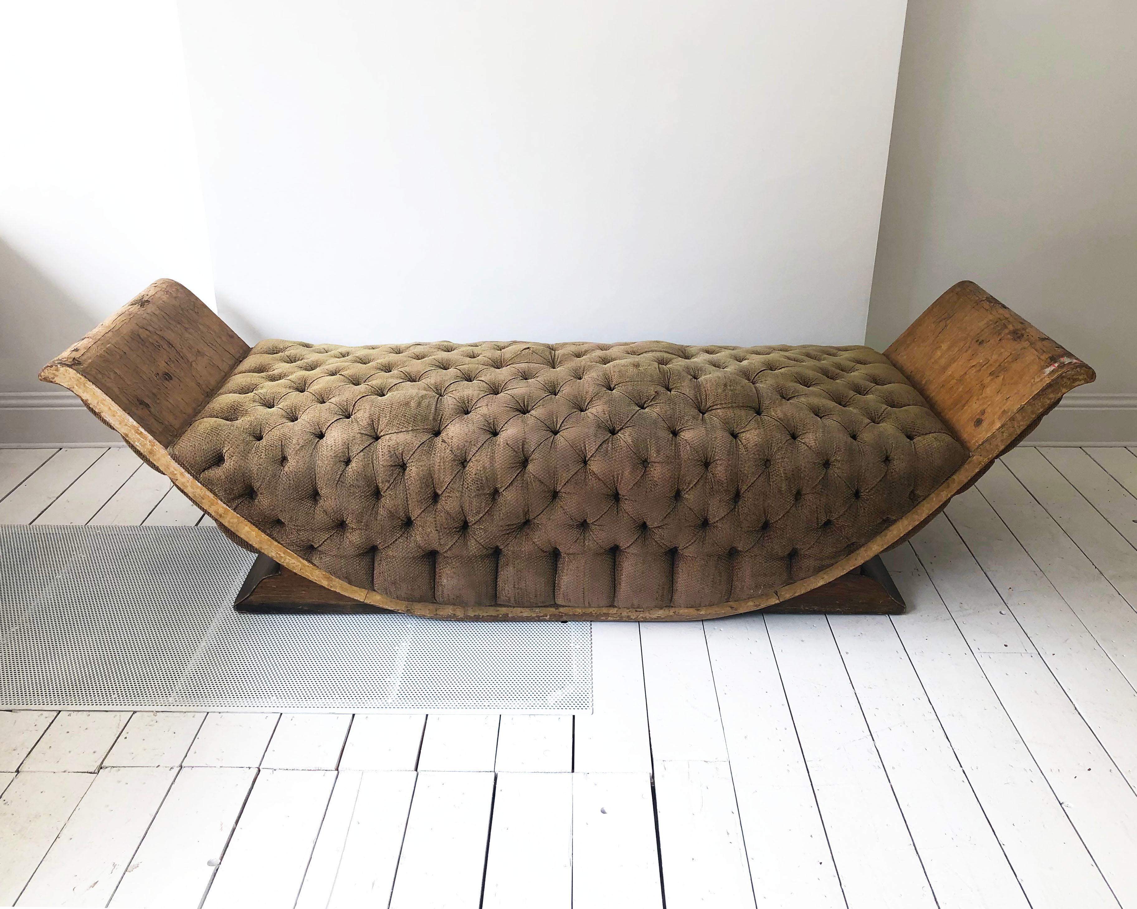 A unique 1930s Art Deco chaise lounge in the shape of gondola made out of burl walnut veneer and buttoned brown upholstery. The daybed talks history with its distressed look which shows its age and use over the decades but its very a comfortable
